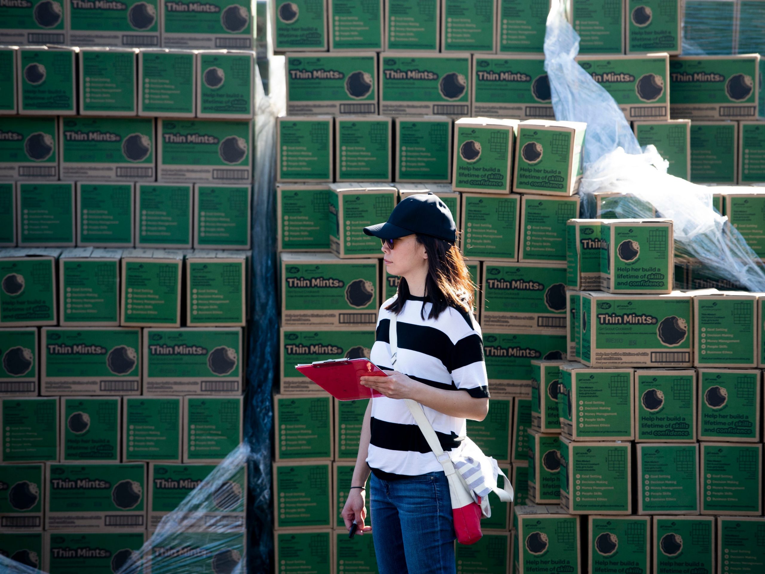 Cookie coordinator Debbie Reynolds, 39, of Villa Park, from Troop 4055, stands next a stack of Thin Mints during the Girl Scout Cookie Mega Drop at the Anaheim.