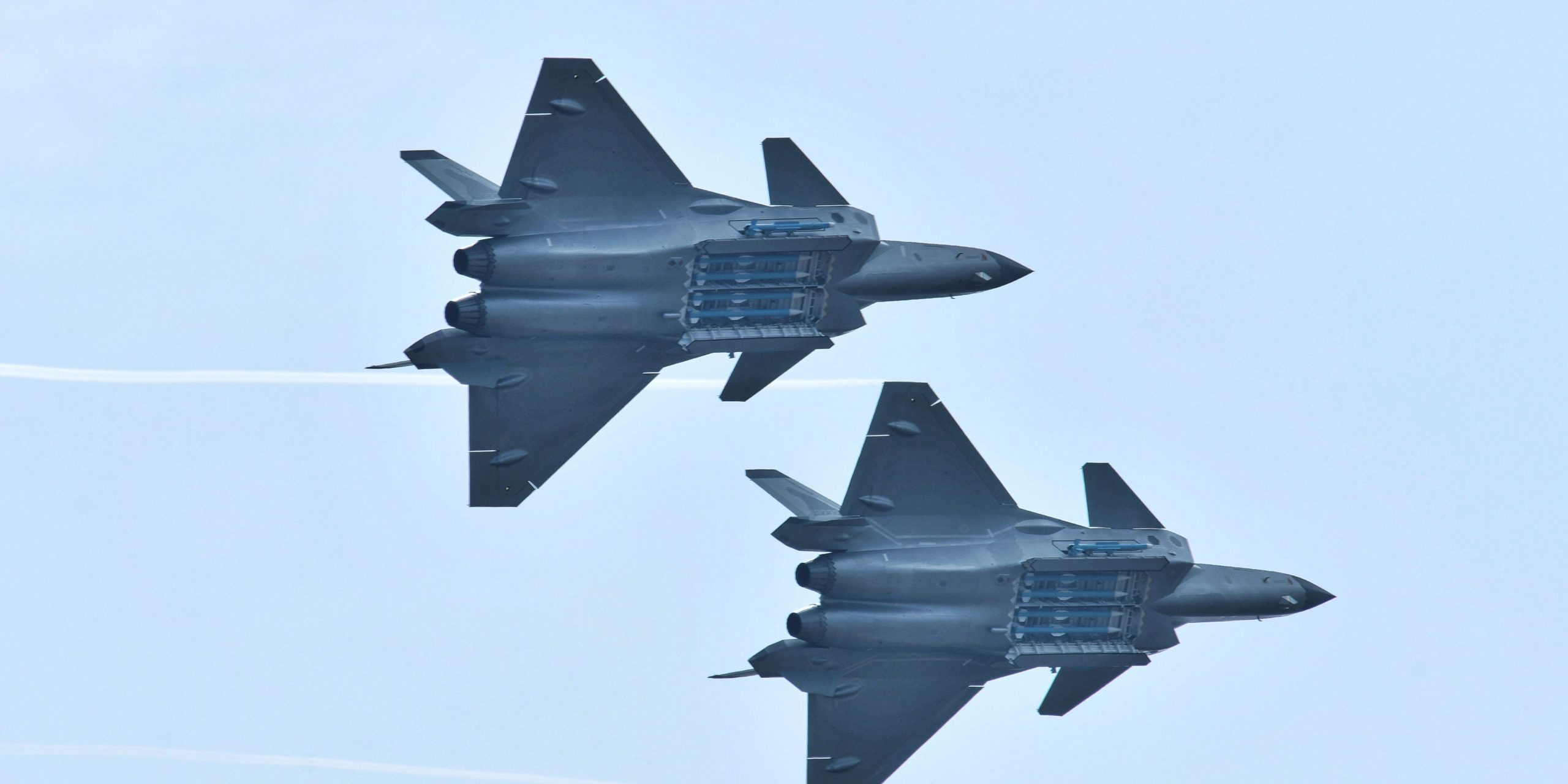 J-20 stealth fighters of PLA Air Force perform with open weapon bays during the Zhuhai Airshow