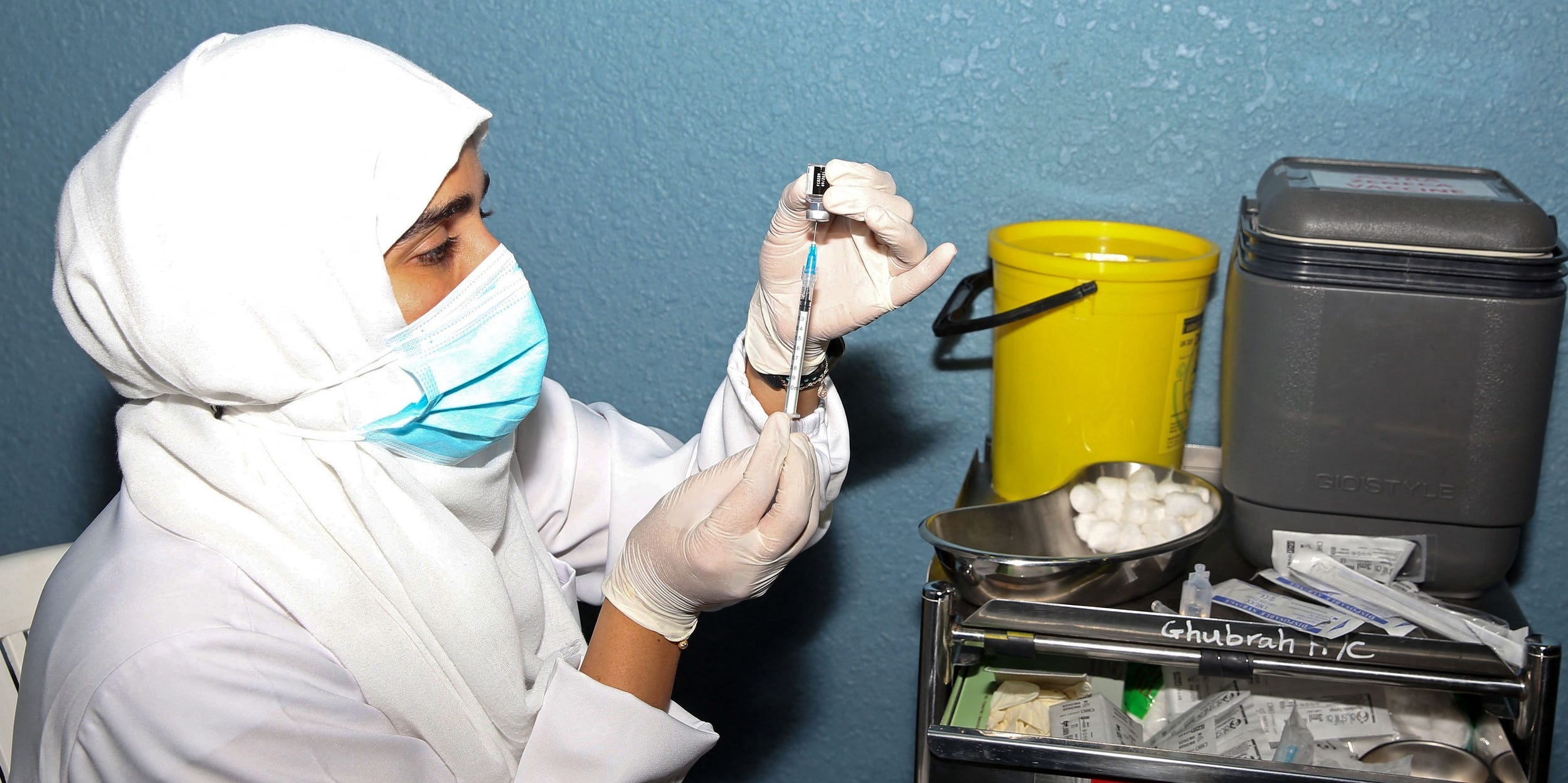 Omani healthcare worker prepares a dose of the Pfizer/BioNTech Covid-19 vaccine at the Sultan Qaboos Sports Complex in Oman's capital Muscat on June 8, 2021.