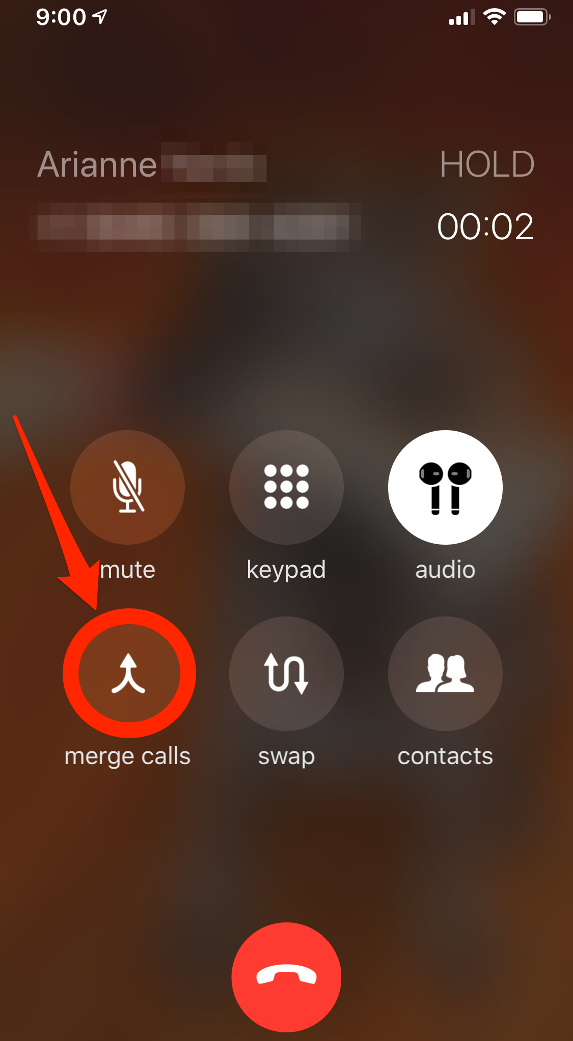 Two calls in progress on an iPhone, tap "merge calls" to combine them