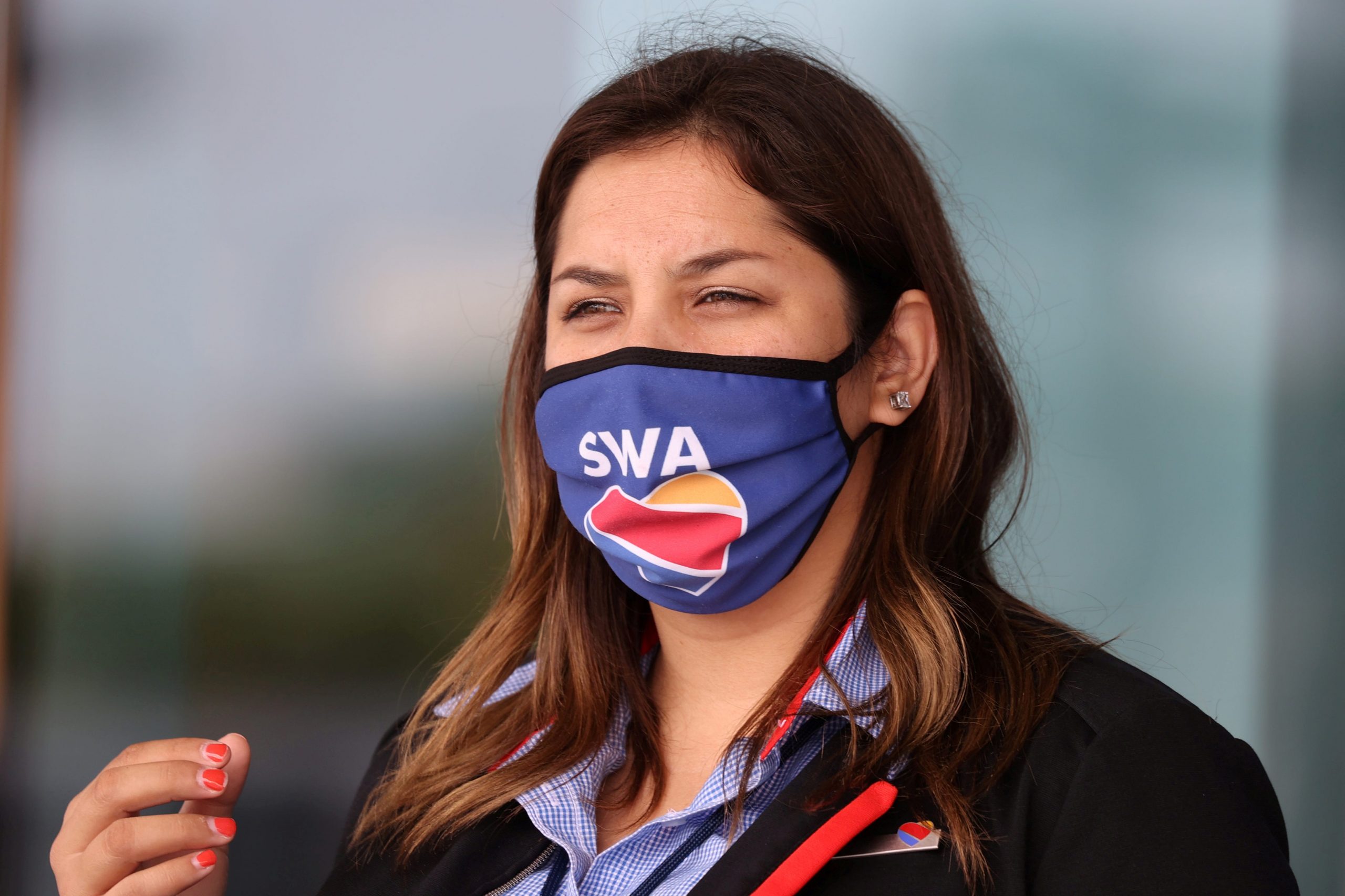 A gate agent wears a Southwest Airlines mask
