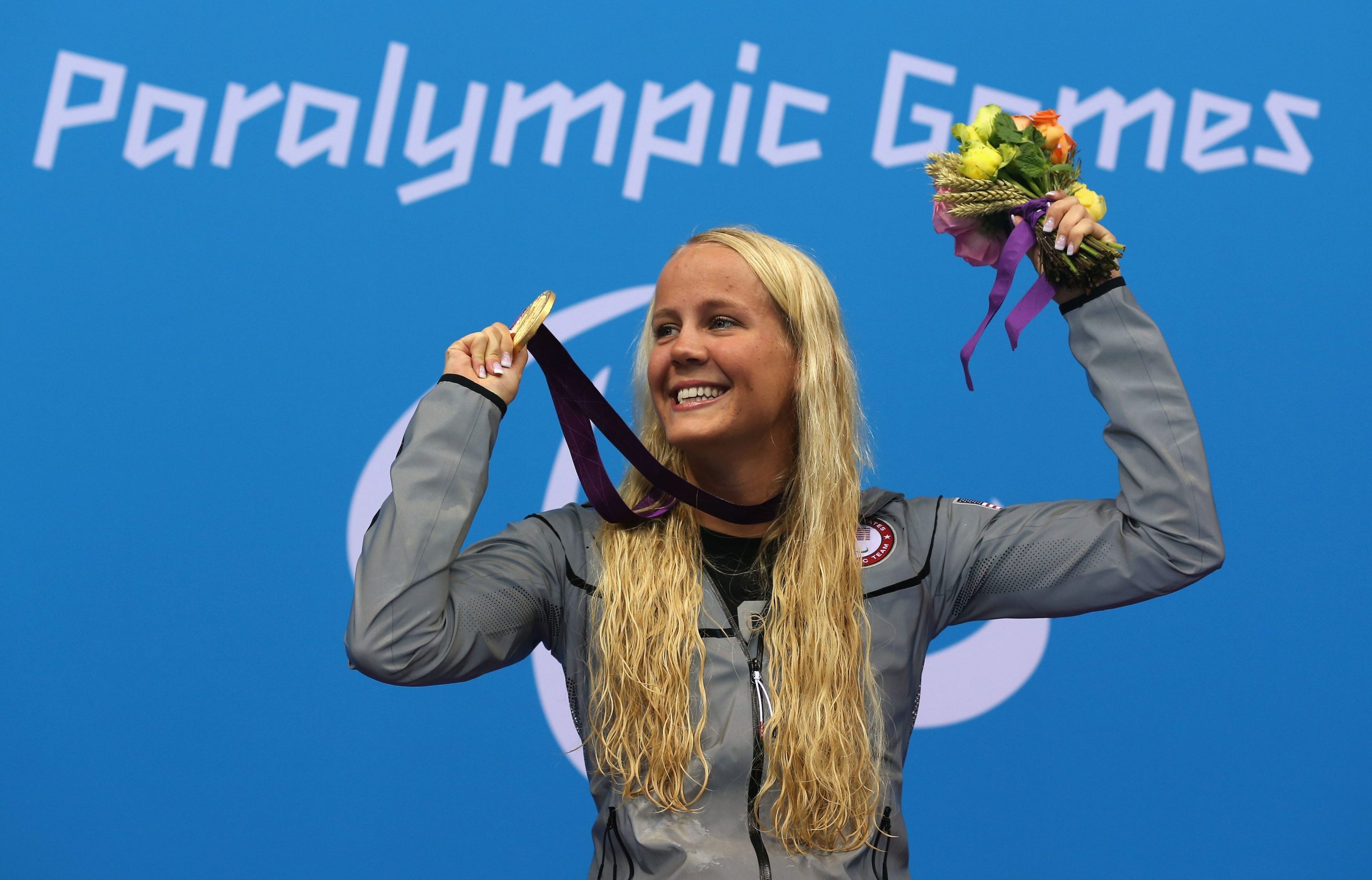 Mallory Weggemann with a gold medal and flowers at the London 2012 Paralympic Games.