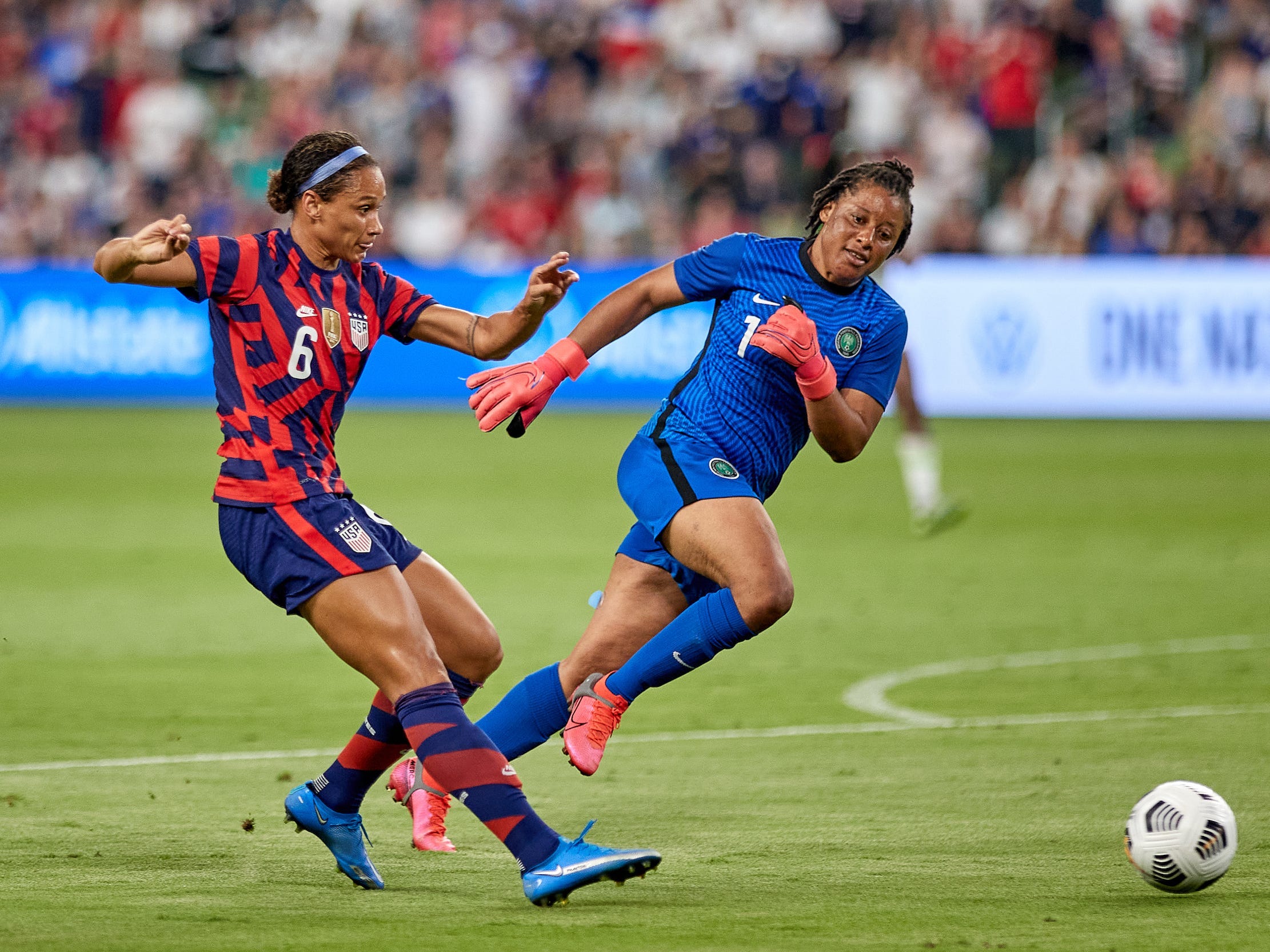 Lynn Williams of the USWNT shoots the ball past Nigeria's goalkeeper.