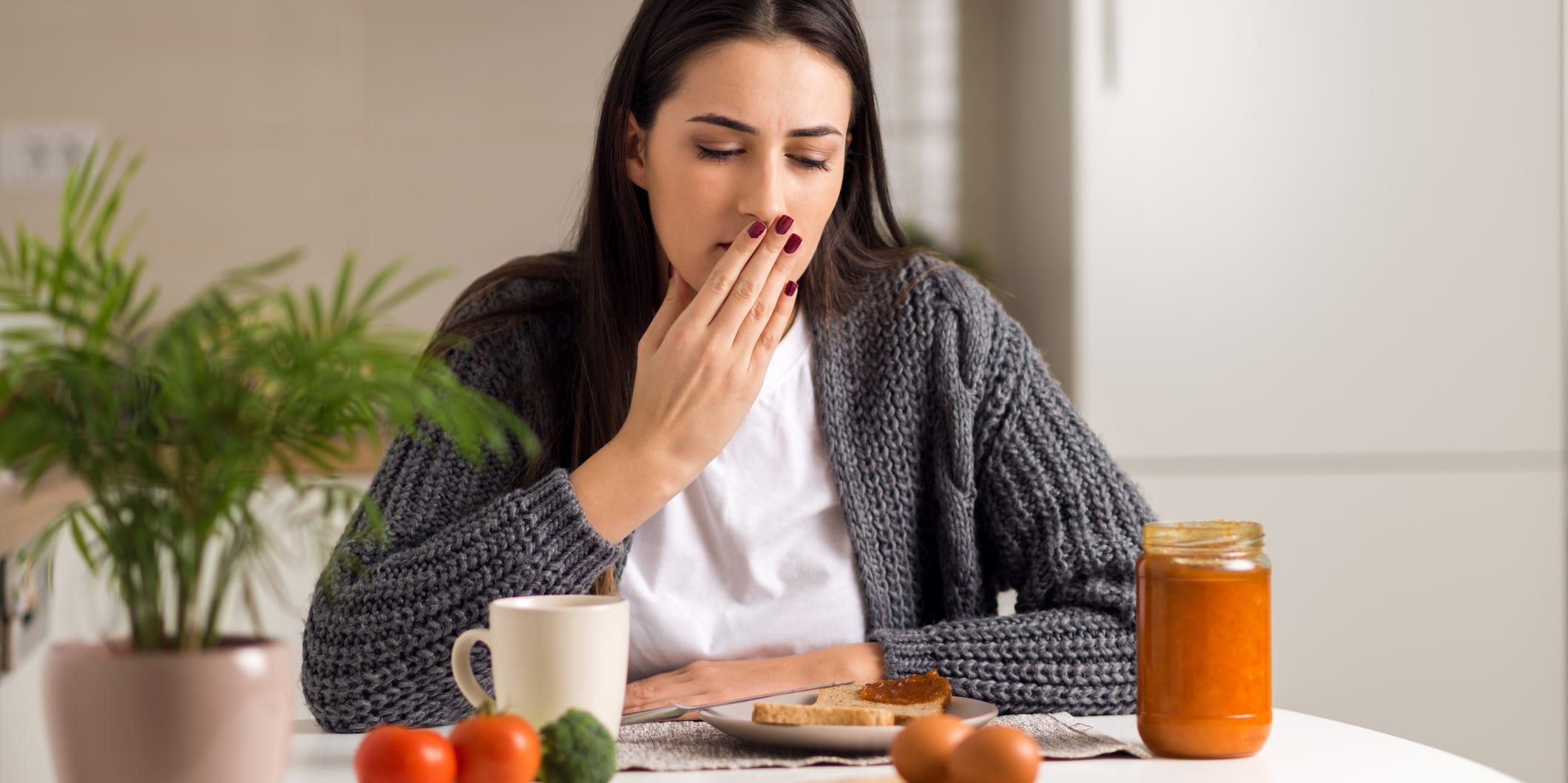 woman nauseous before during or after a meal