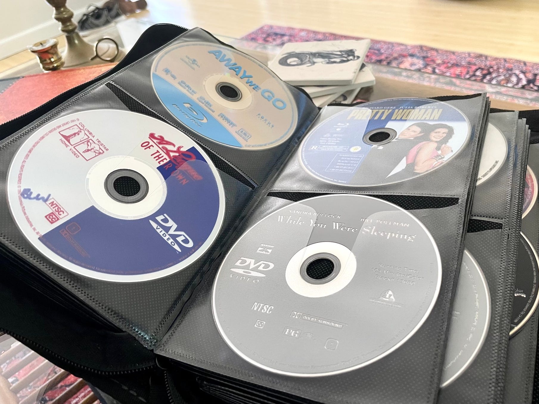 A case holds DVDs on a table