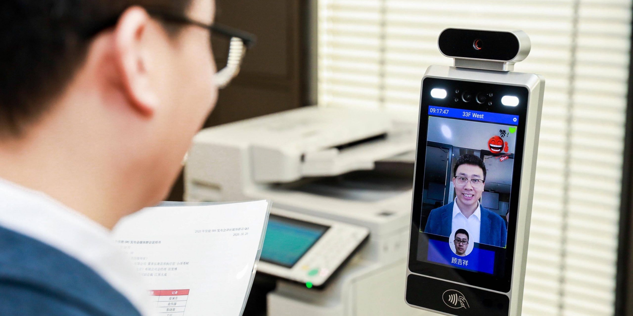 A man smiles for an AI camera facial recognition system