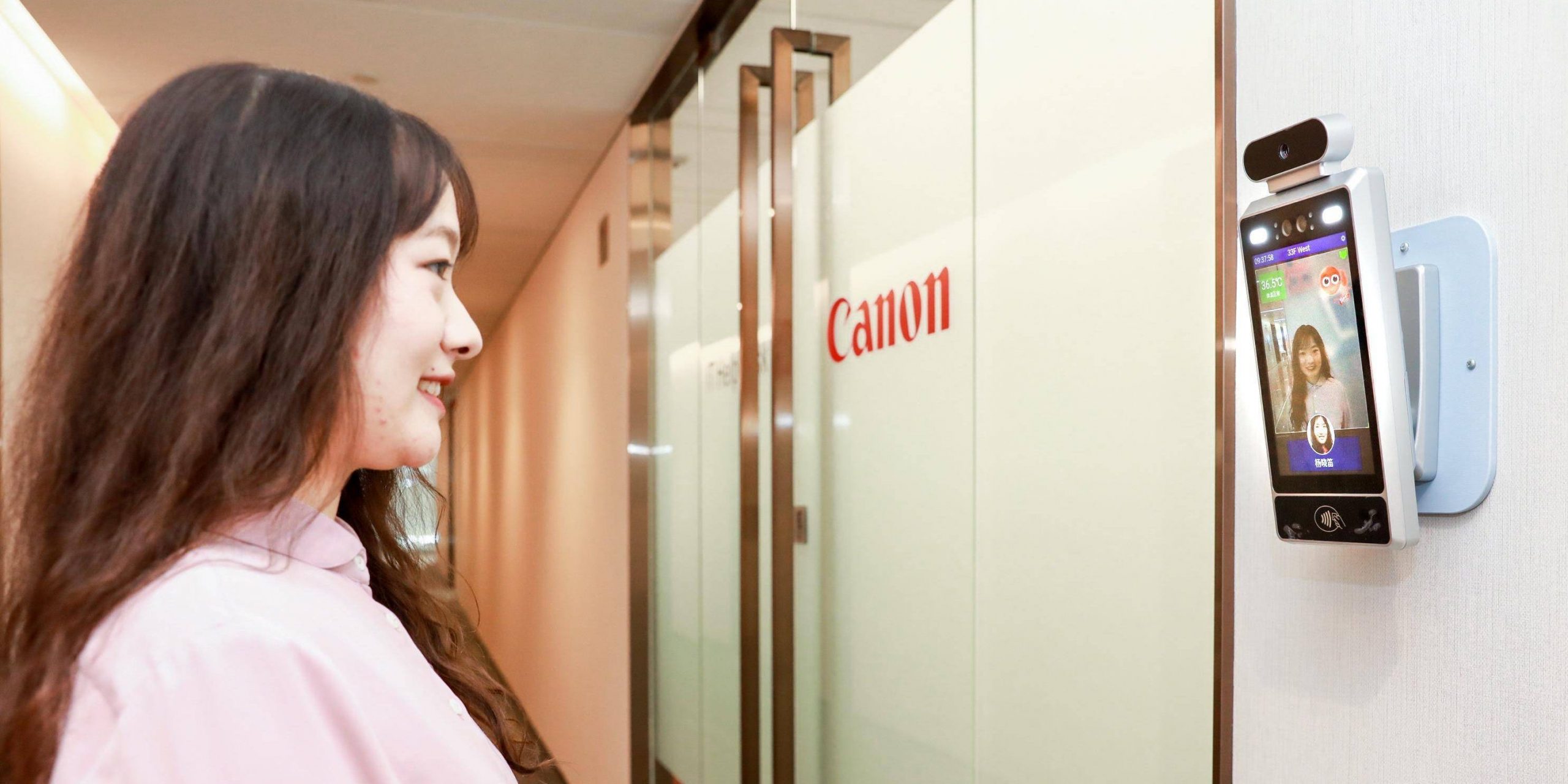 A woman smiles at an AI camera