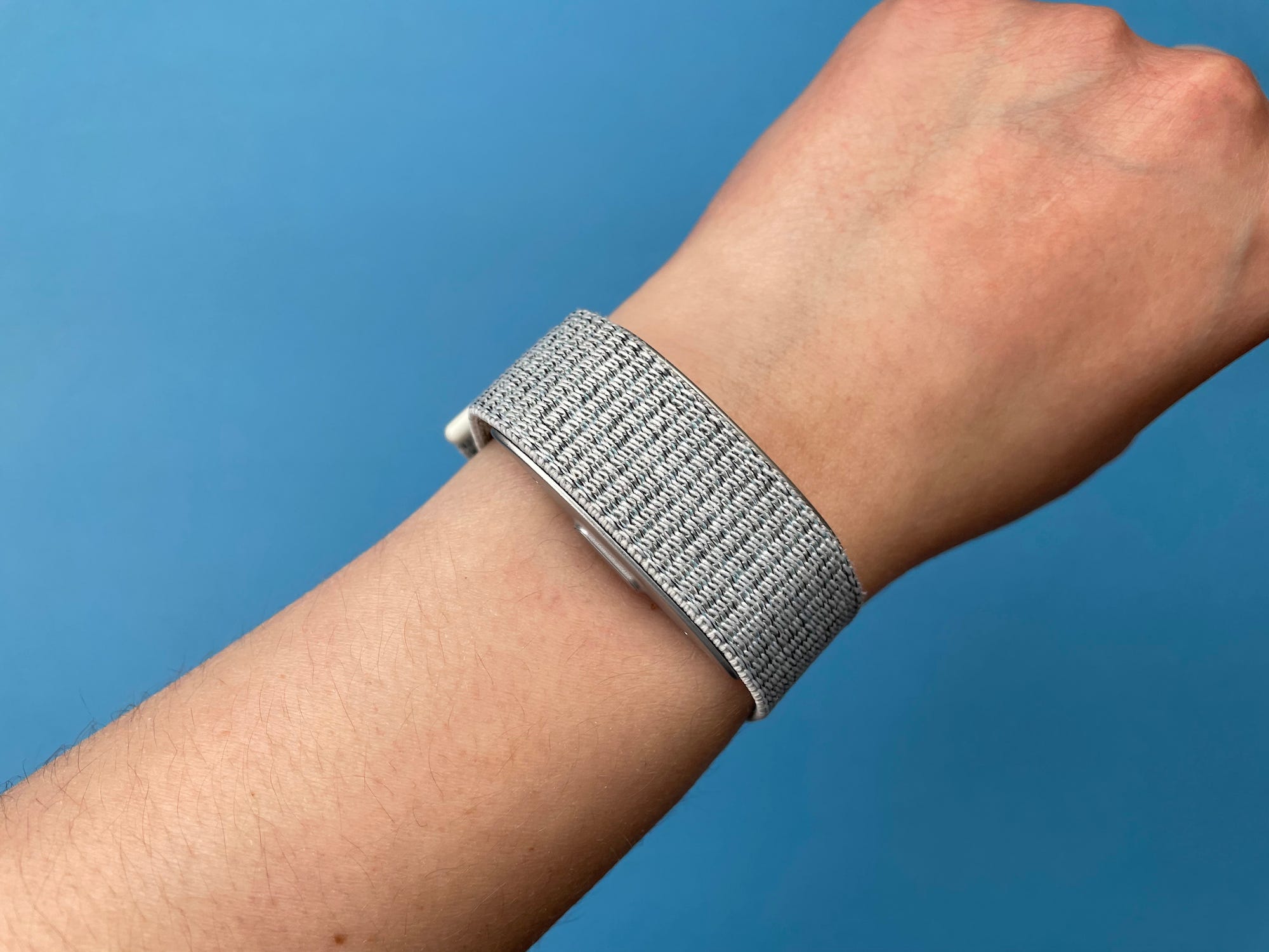 The Amazon Halo band in silver being worn on someone's wrist