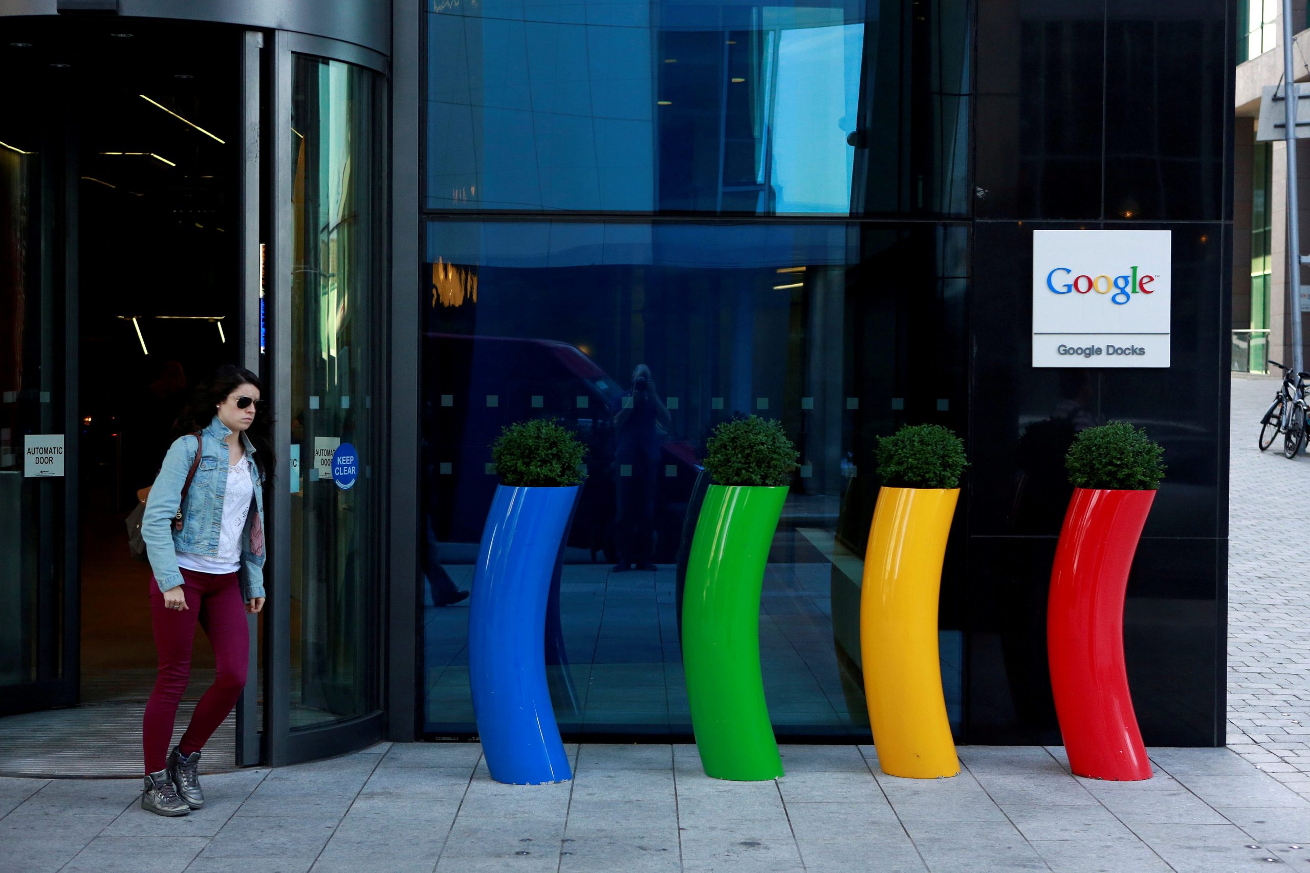 A woman wearing sunglasses exits Google's Dublin headquarters