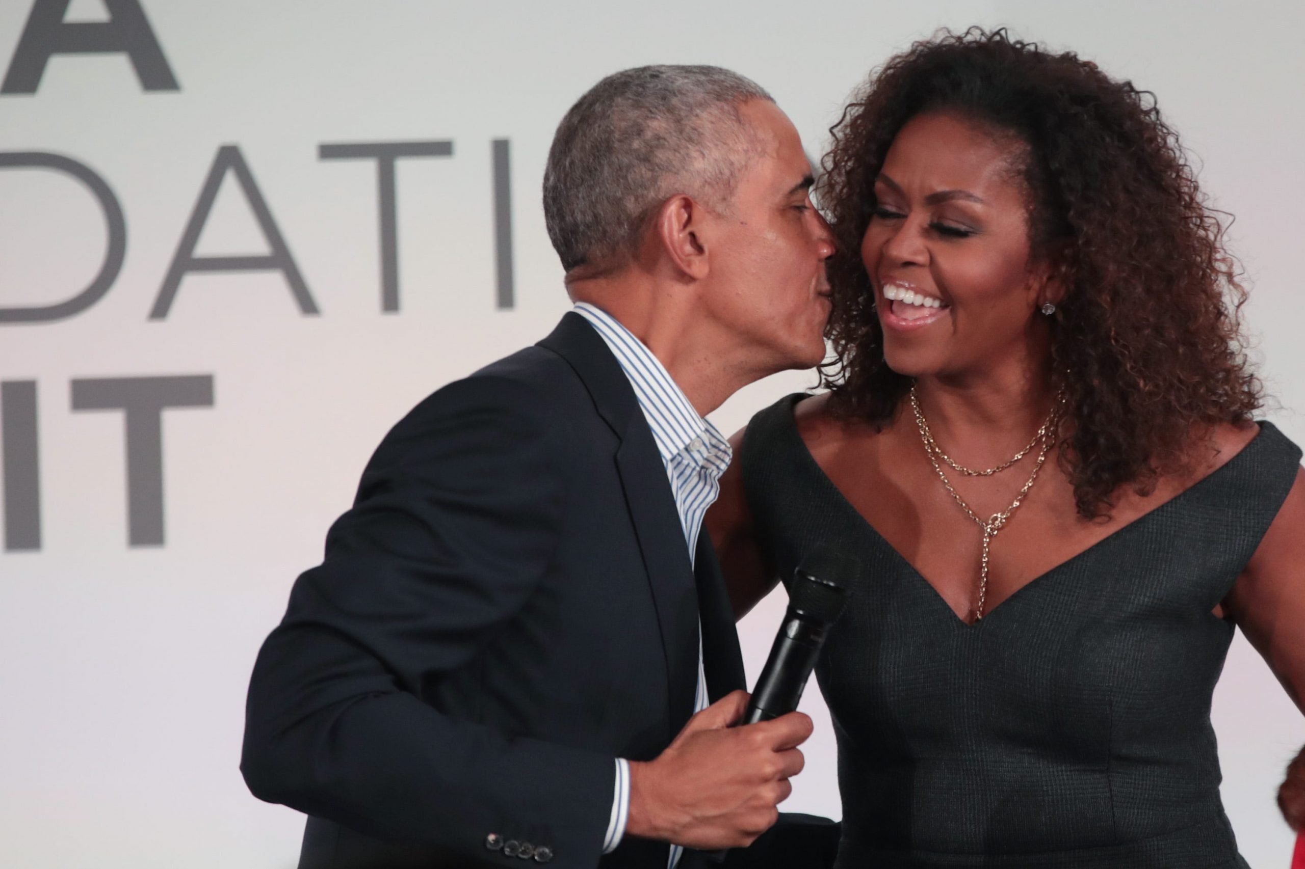 Former President Barack Obama leans in to give his wife, Michelle Obama, a kiss at the Obama Foundation Summit in 2019.