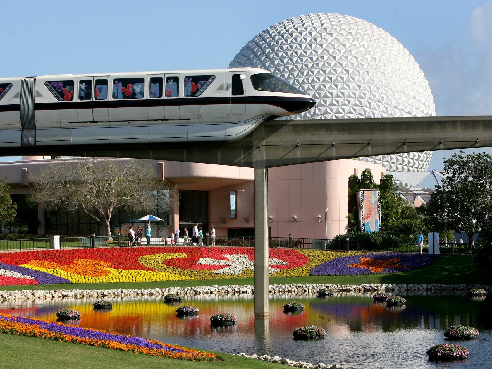 The monorail in Disney World rides past Spaceship Earth at Epcot.