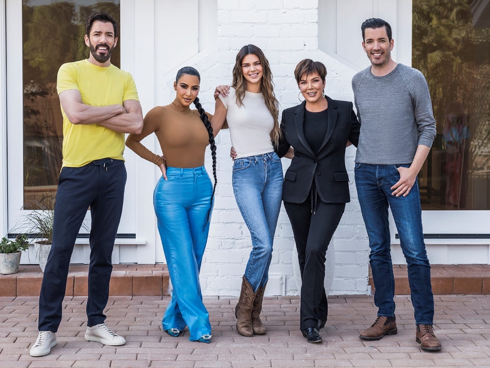 Drew Scott, Kim Kardashian West, Kendall Jenner, Kris Jenner, and Jonathan Scott pose with their arms around each other.