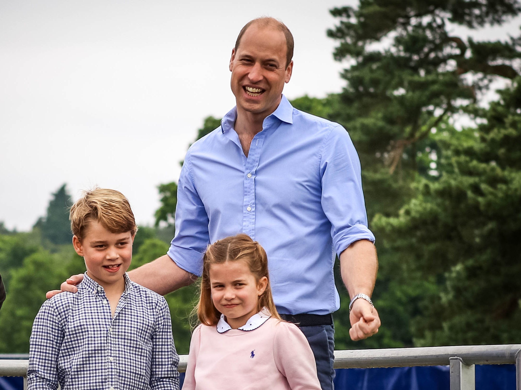 Prince William speaking to runners at the Sandringham Half Marathon with Prince George and Princess Charlotte.
