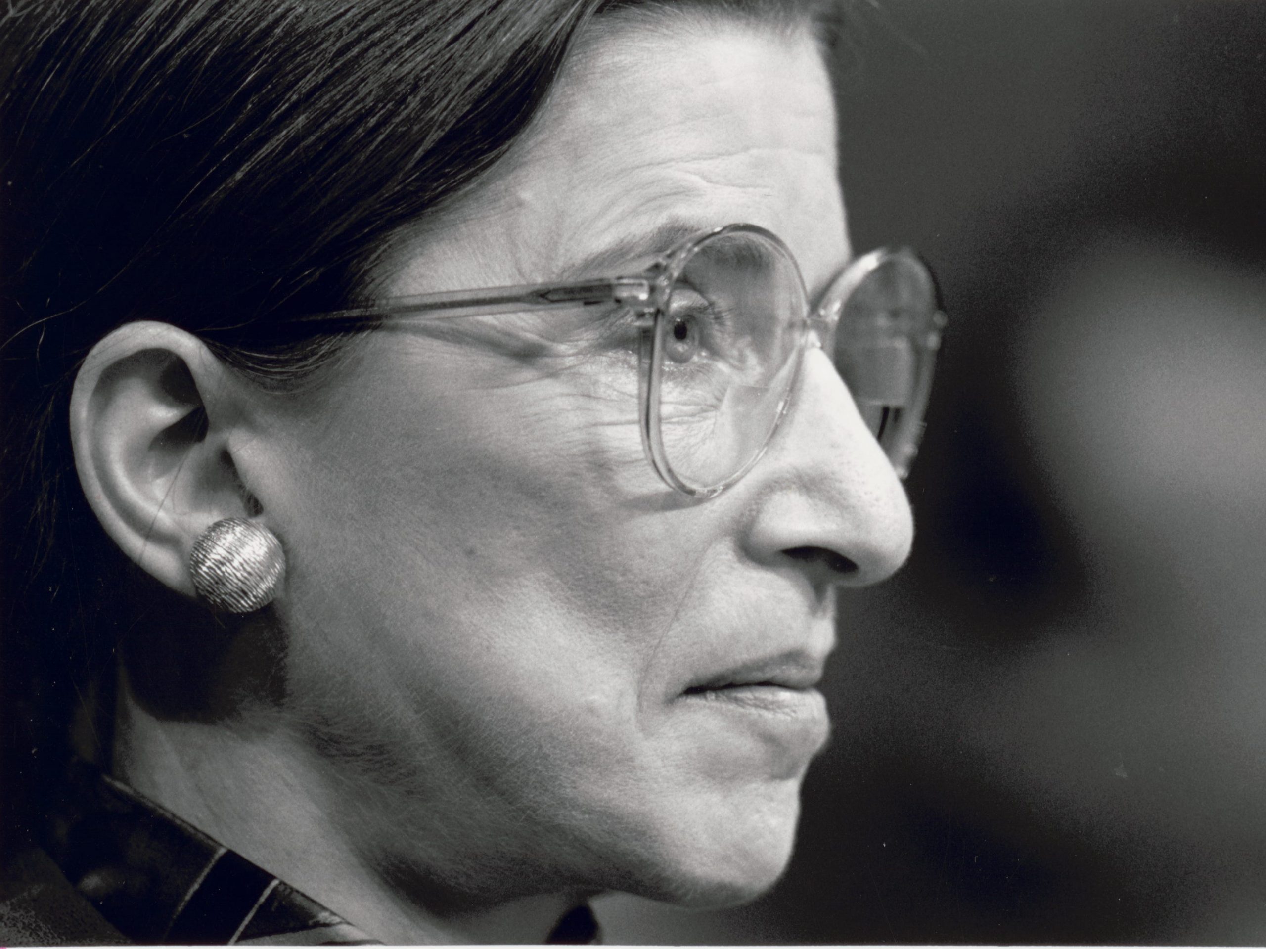 Ruth Bader Ginsberg looking out of frame wearing glasses