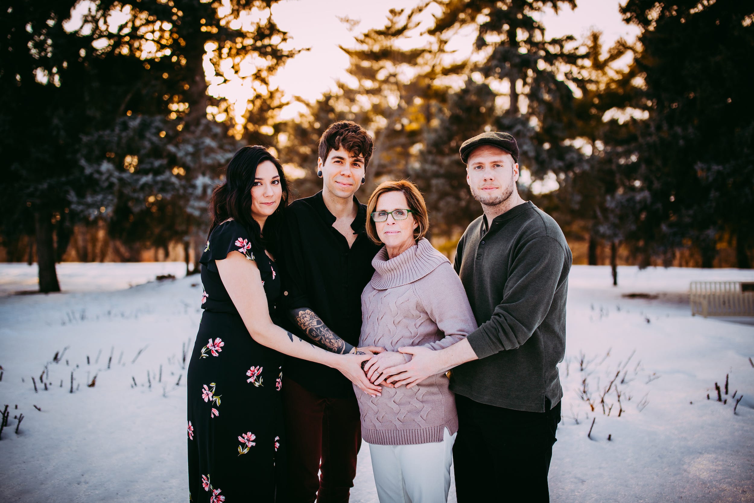 The Durt family stands in the snow with Matt's mom, who is pregnant with their baby, and Elliot's sister, who donated her egg.