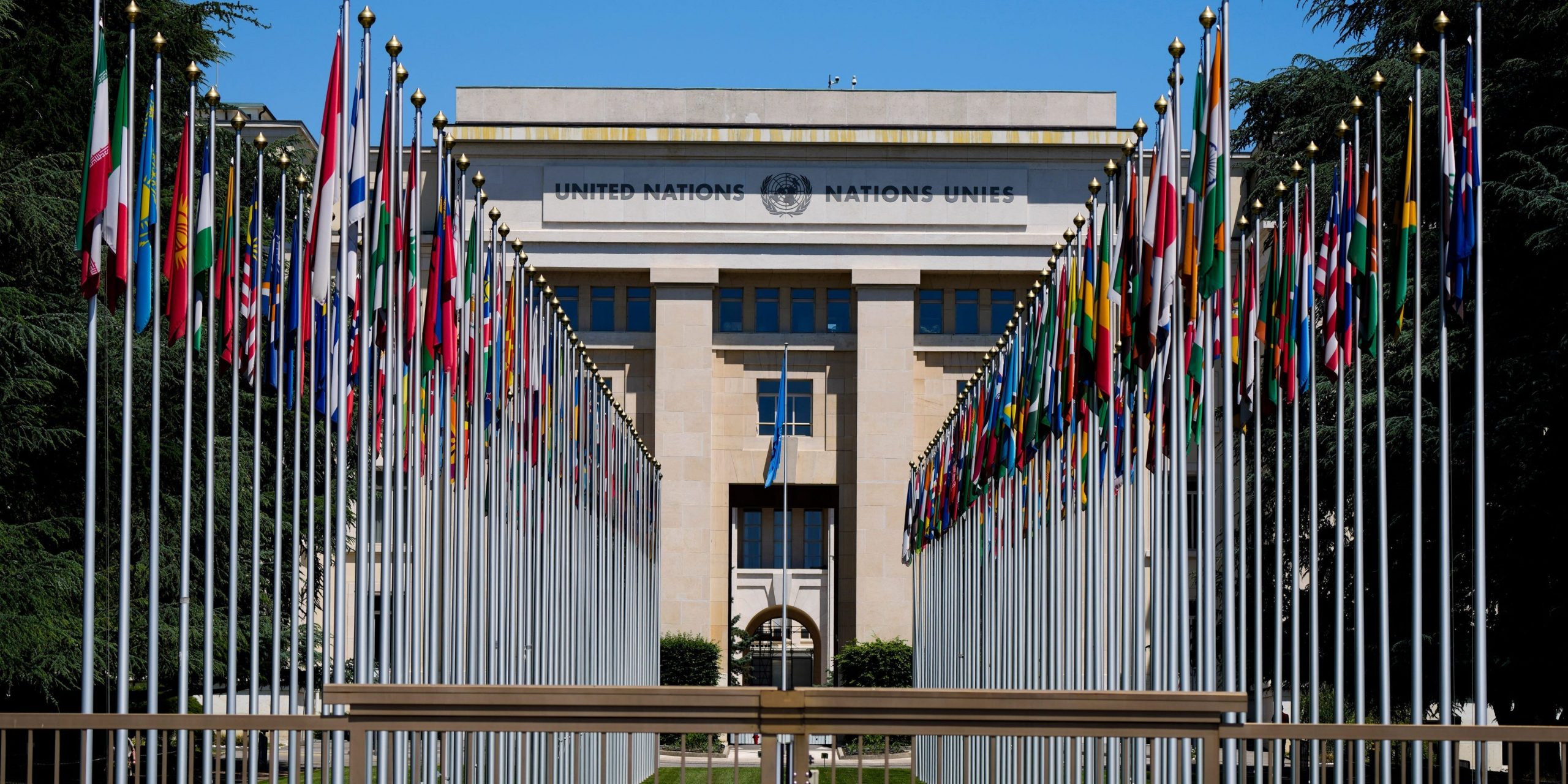 Flagpoles line in rows in front of a building of the United Nations in Geneva, Switzerland Monday, June 14, 2021.