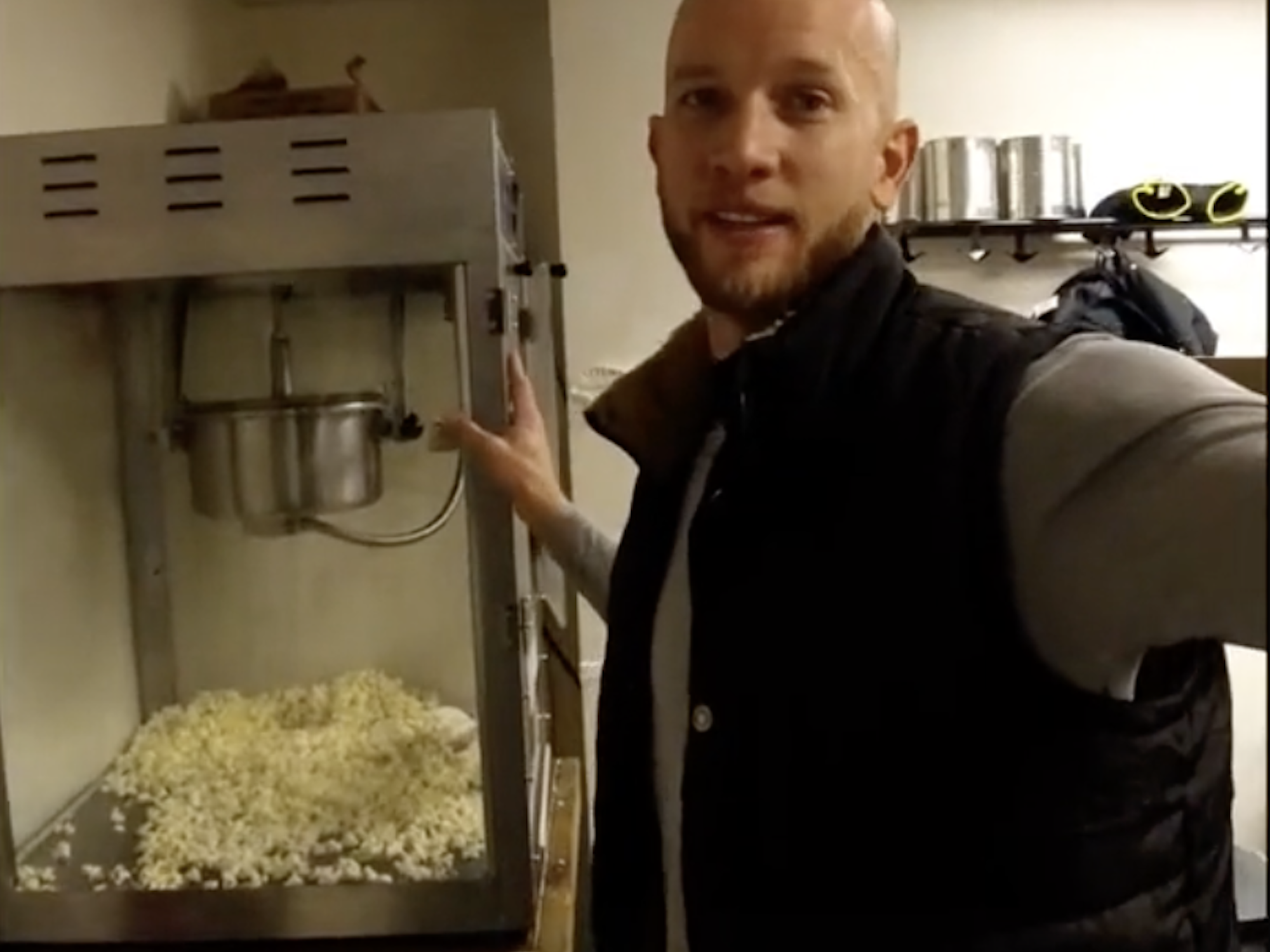 Josiah Horneman points to a popcorn machine in the background at the Amundsen-Scott South Pole Station.