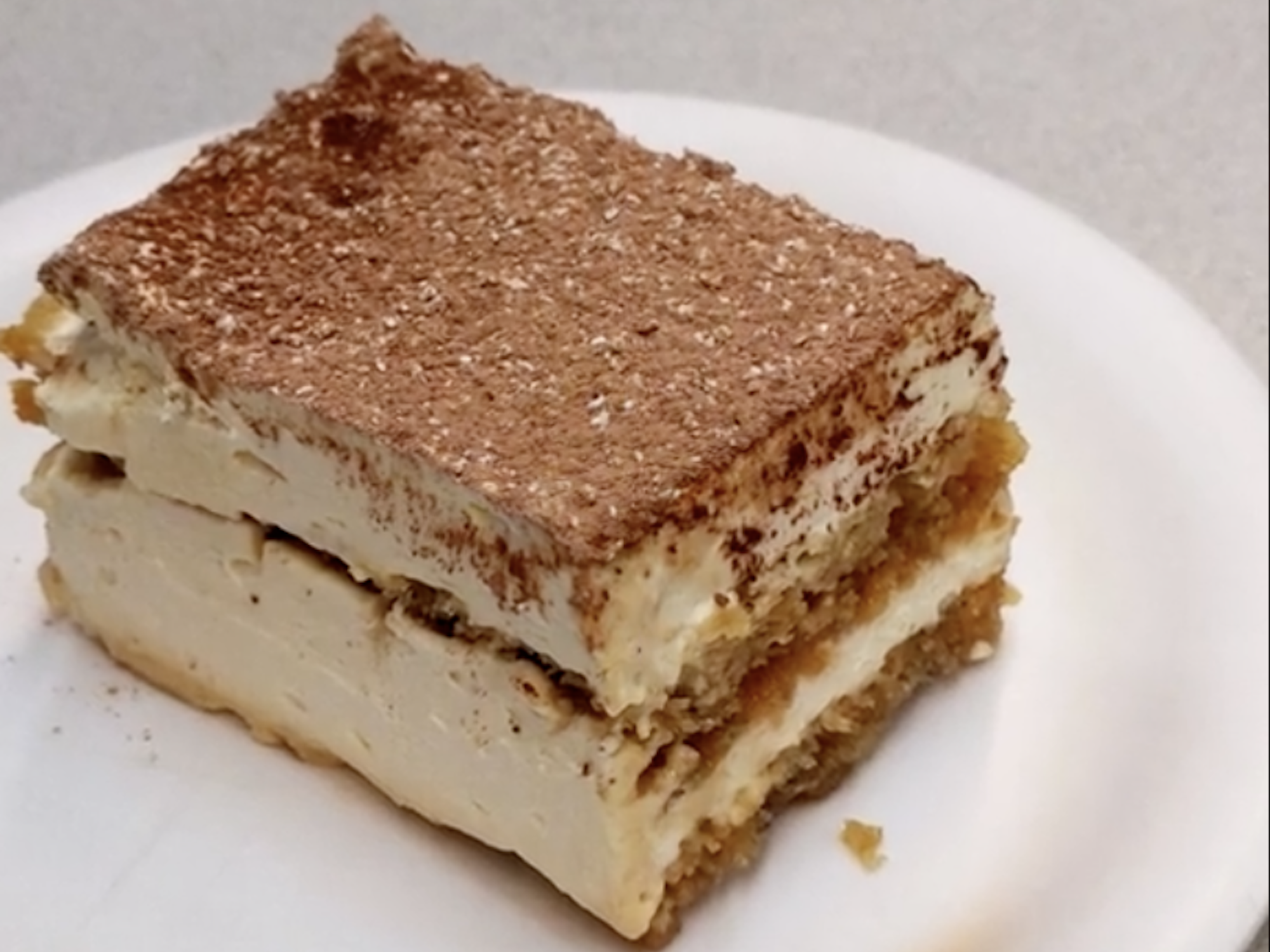 A slice of tiramisu on a plate, filmed by Josiah Horneman at the Amundsen-Scott South Pole Station.