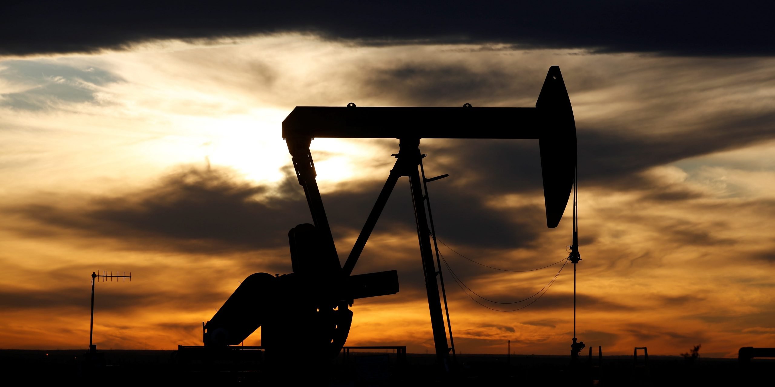 FILE PHOTO: The sun sets behind a crude oil pump jack on a drill pad in the Permian Basin in Loving County, Texas, U.S. November 24, 2019.  REUTERS/Angus Mordant