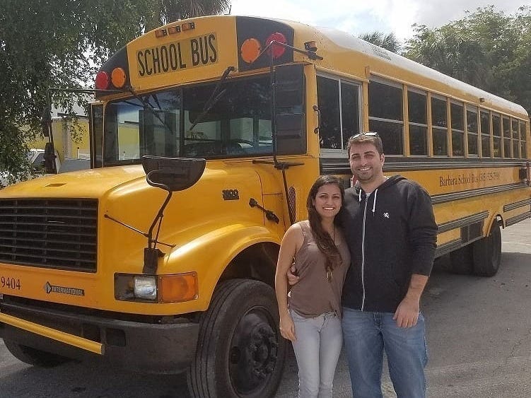 Robbie and Priscilla in front of their 1998 Thomas school bus before they converted it into a mobile home.