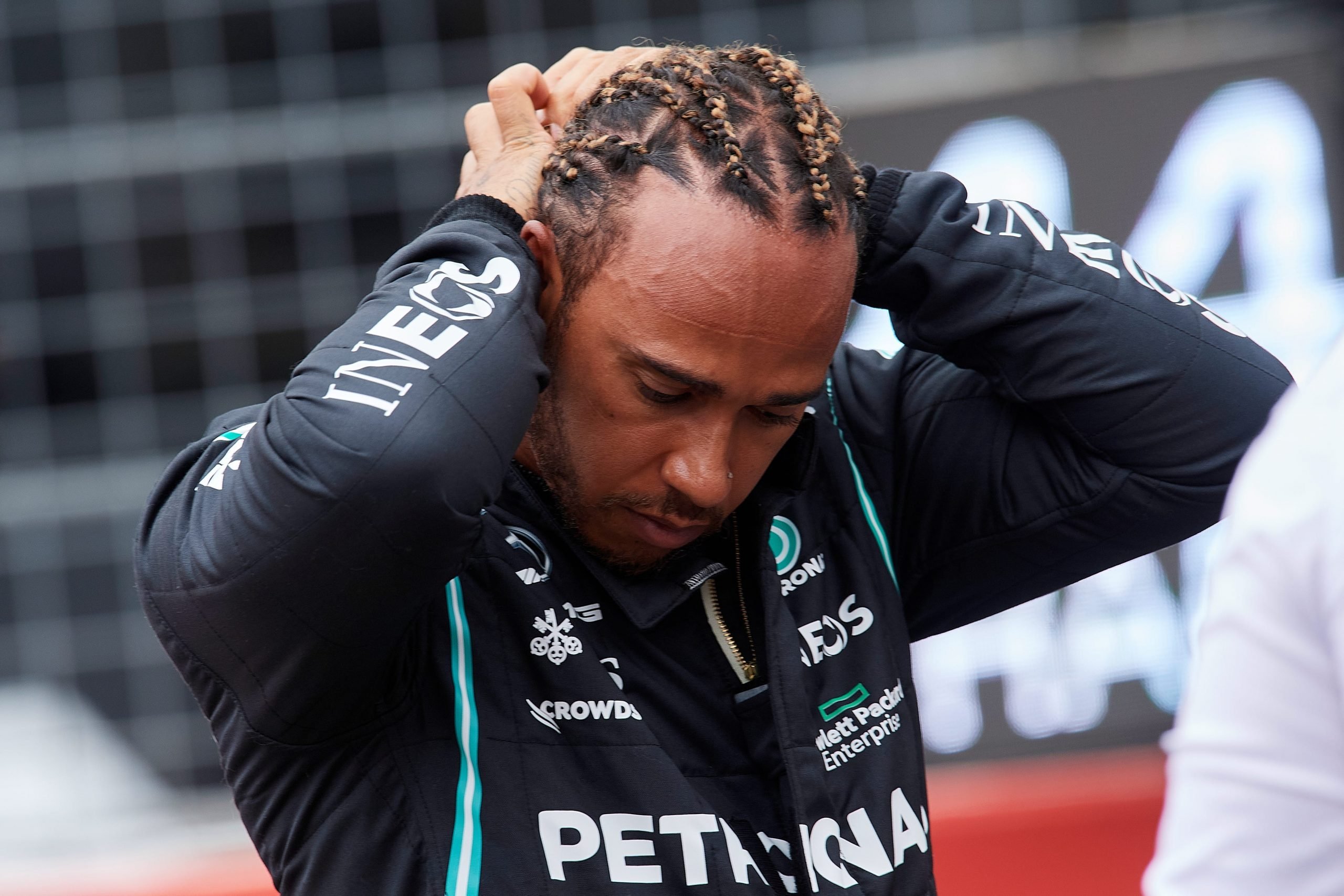 British Formula One driver Lewis Hamilton bows his head after a race