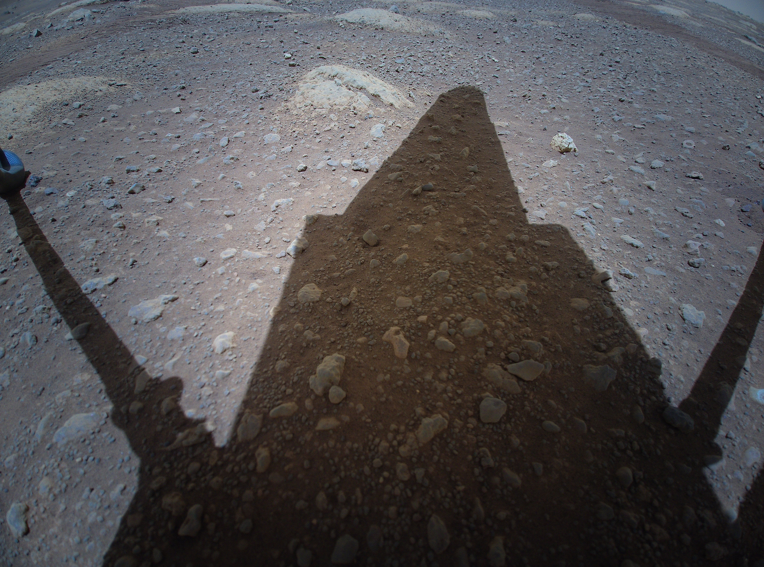 ingenuity helicopter shadow on rocky mars soil