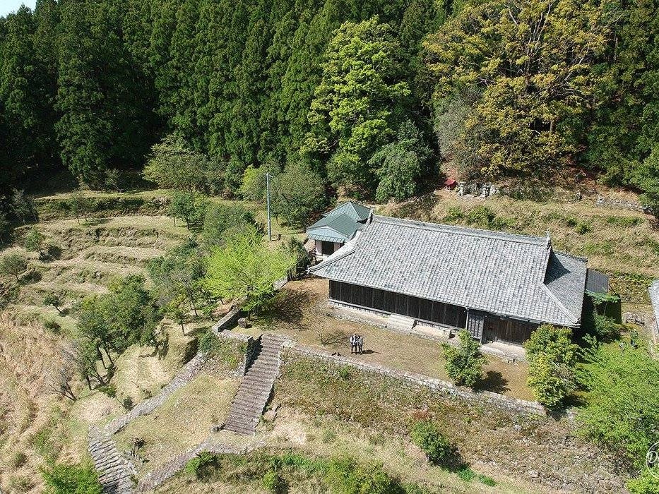 An aerial view of Chizuro Tokai's countryside home surrounded by fields and trees