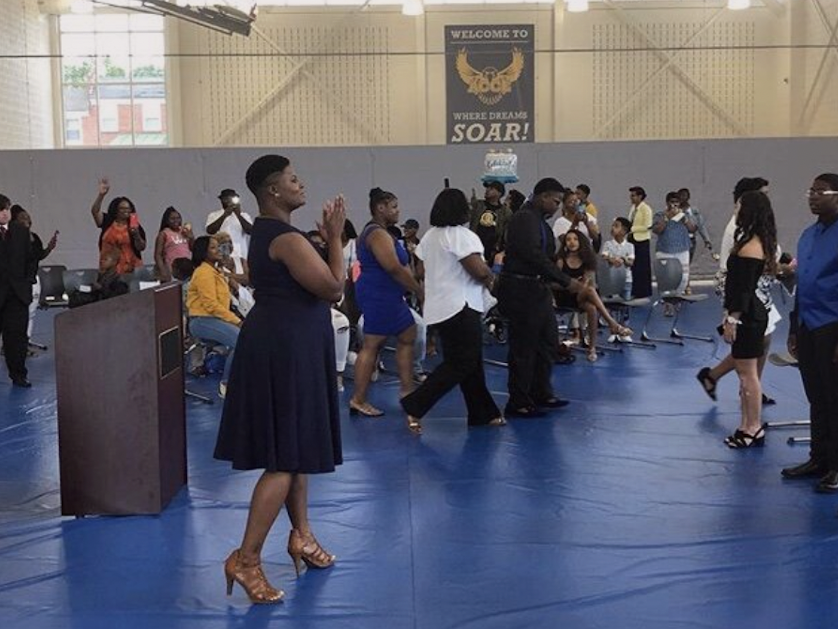 Chimére Smith, a middle school teacher, is in her school in Baltmore, in the background are children.