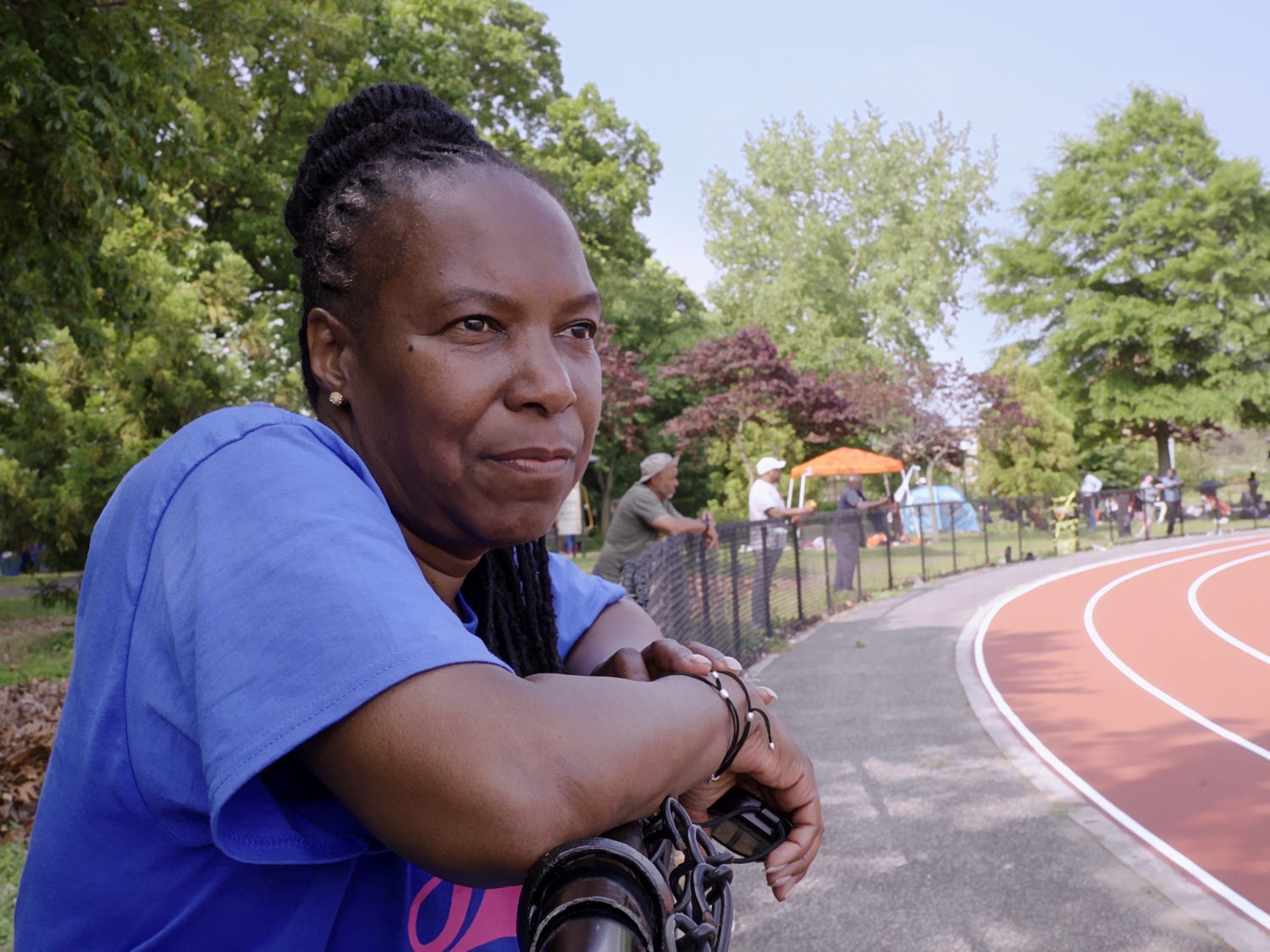 Coach Jean Bell by the side of a running track.