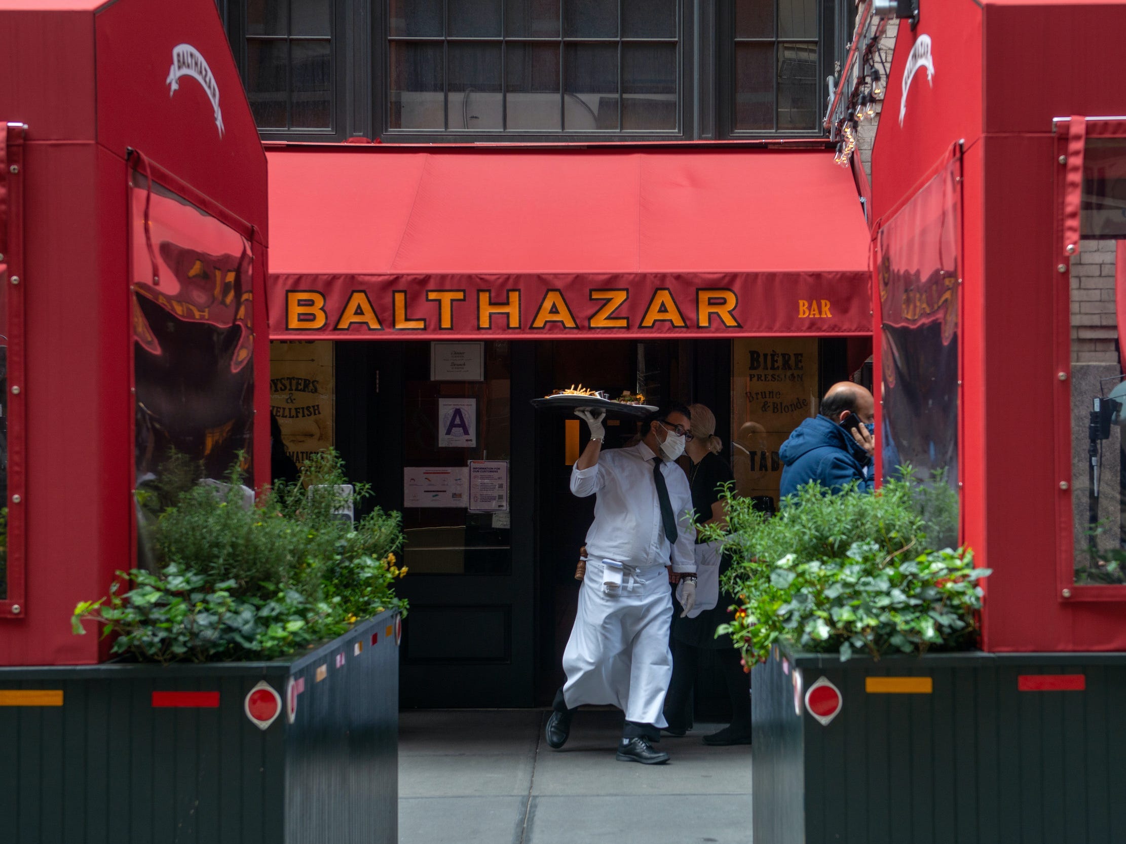 Waiter outside of Balthazar restaurant in New York City