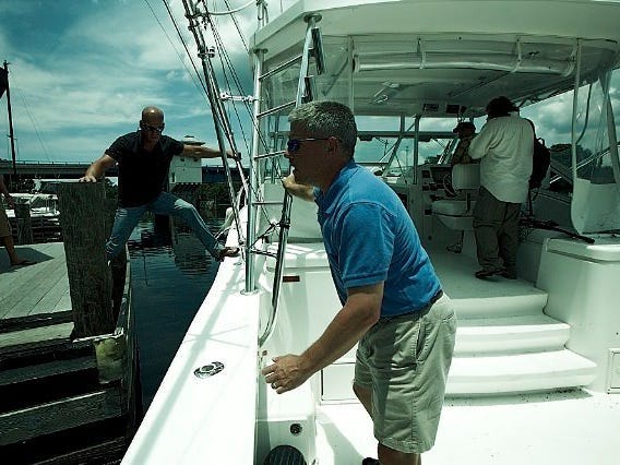 Pulling lines away from the dock to repossess a boat. Ken Cage