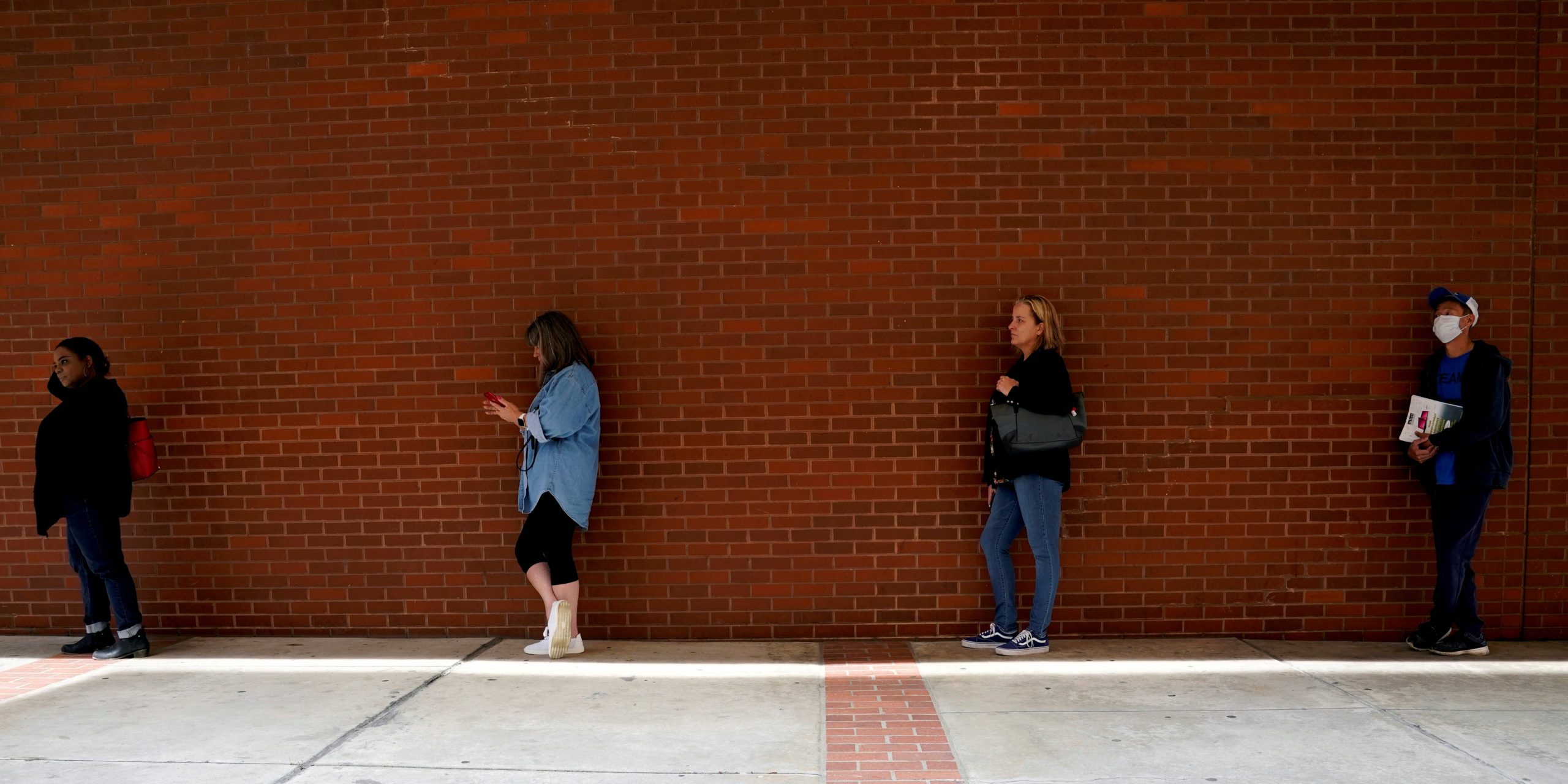 FILE PHOTO: People who lost their jobs wait in line to file for unemployment benefits, following an outbreak of the coronavirus disease (COVID-19), at Arkansas Workforce Center in Fort Smith, Arkansas, U.S. April 6, 2020. REUTERS/Nick Oxford/File Photo