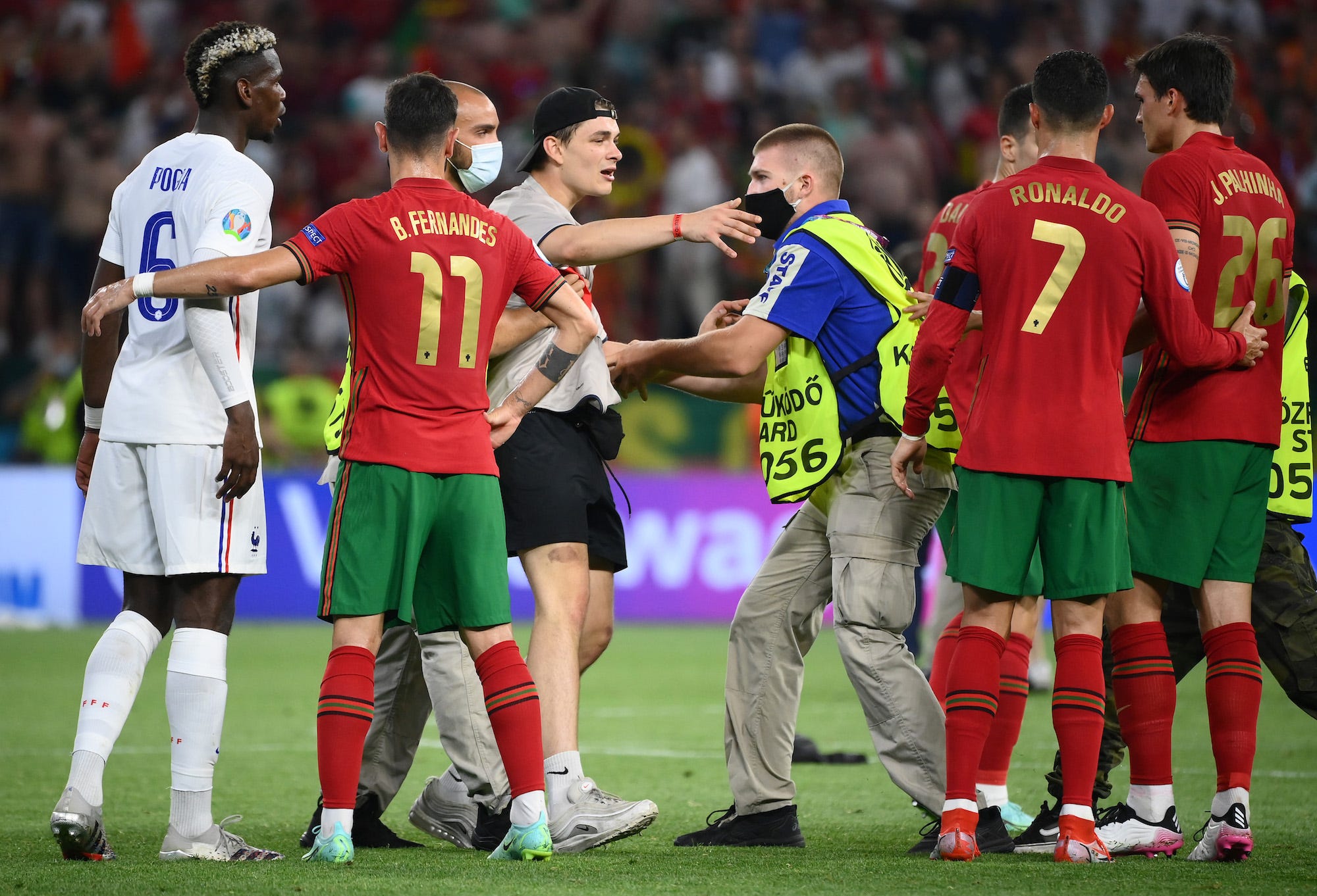 Ronaldo is greeted by a fan who stormed the pitch during Portugal’s game versus France