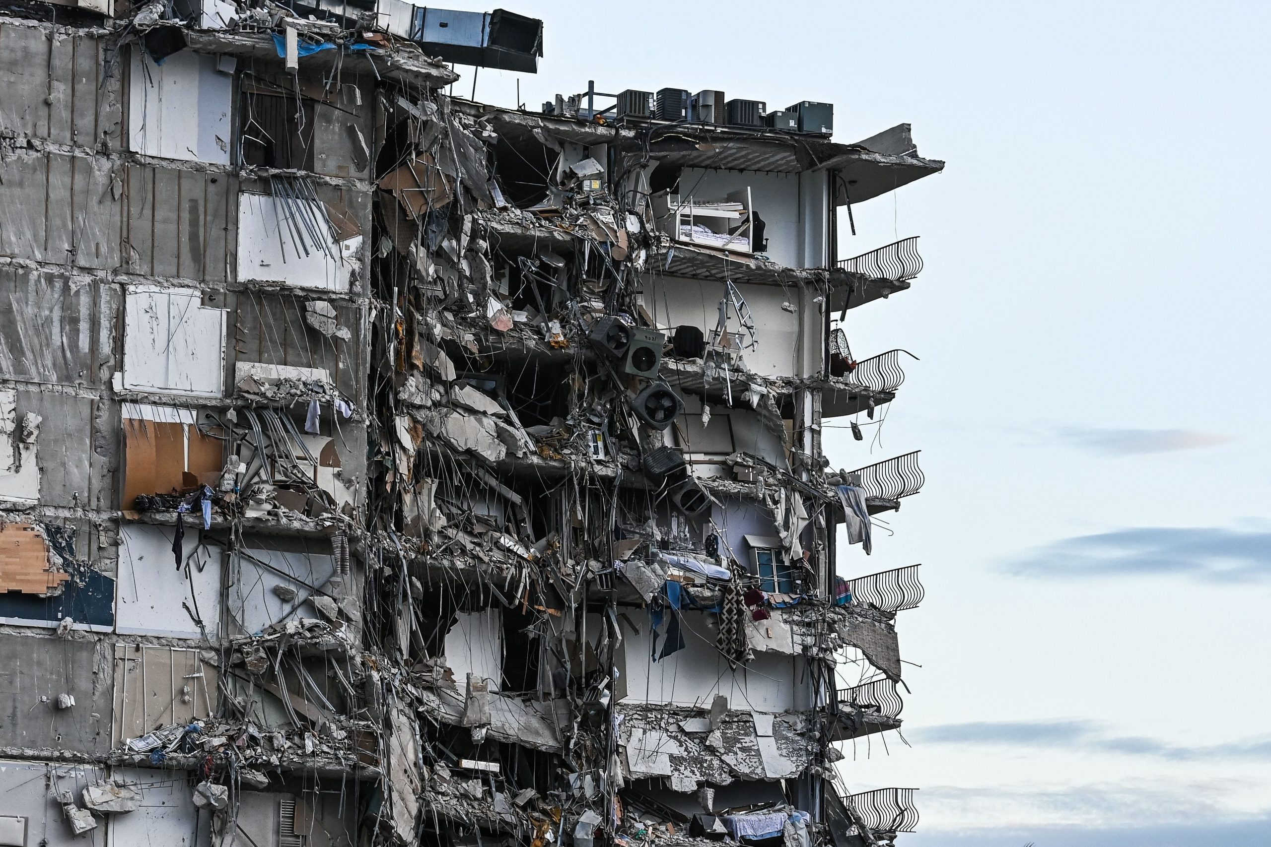 Rubble hangs from a partially collapsed building in Surfside north of Miami Beach, on June 24, 2021.