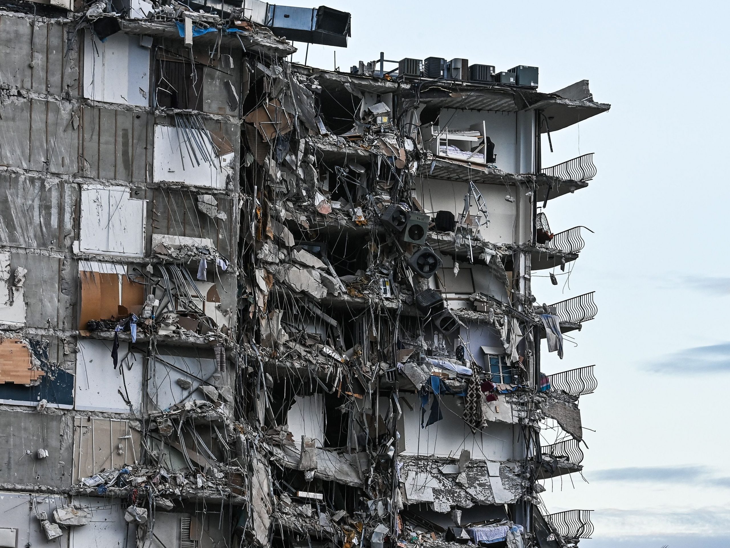 Rubble hangs from a partially collapsed building in Surfside north of Miami Beach, on June 24, 2021.