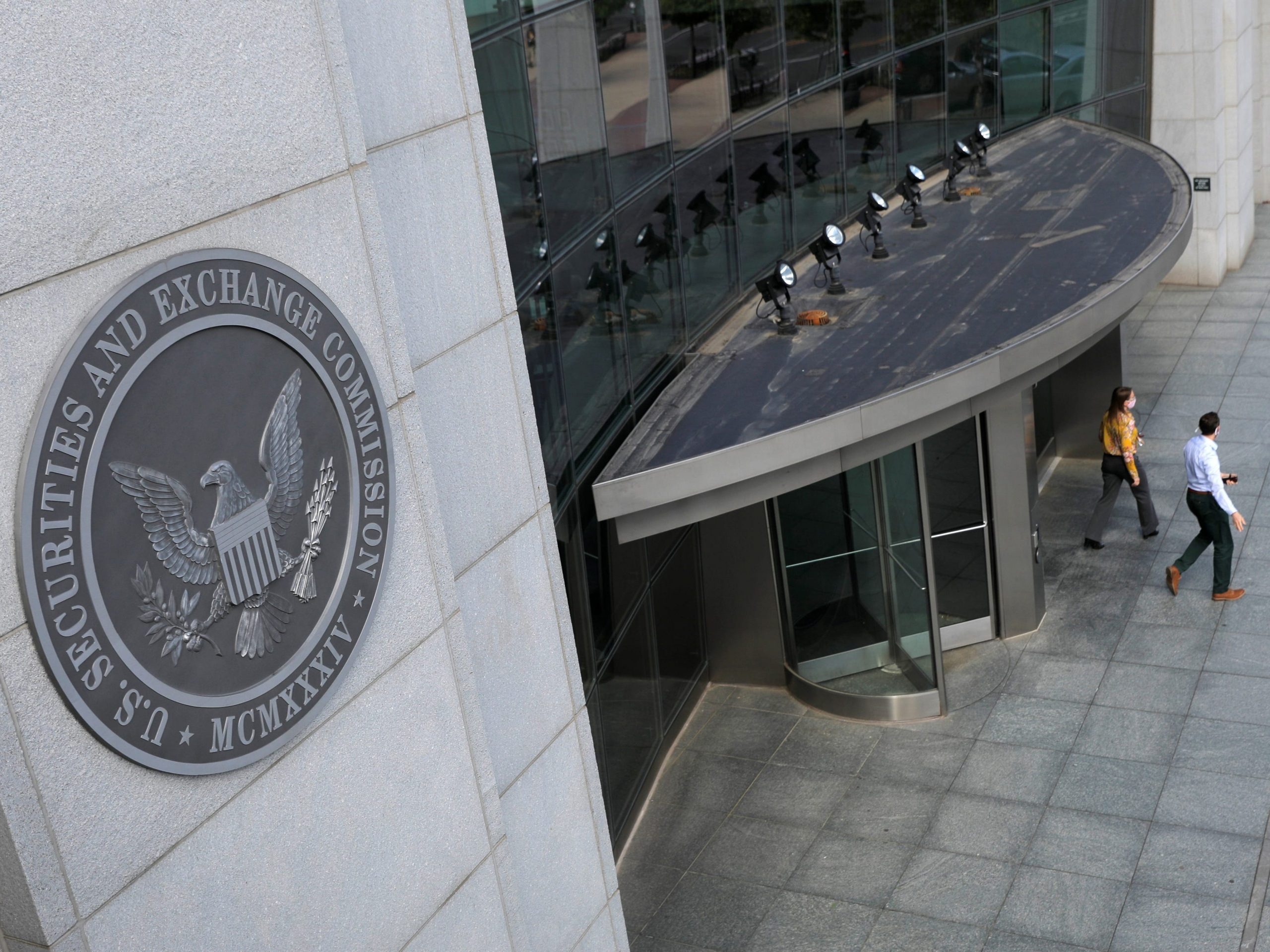 People walking out of the SEC building US Securities and Exchange Commission