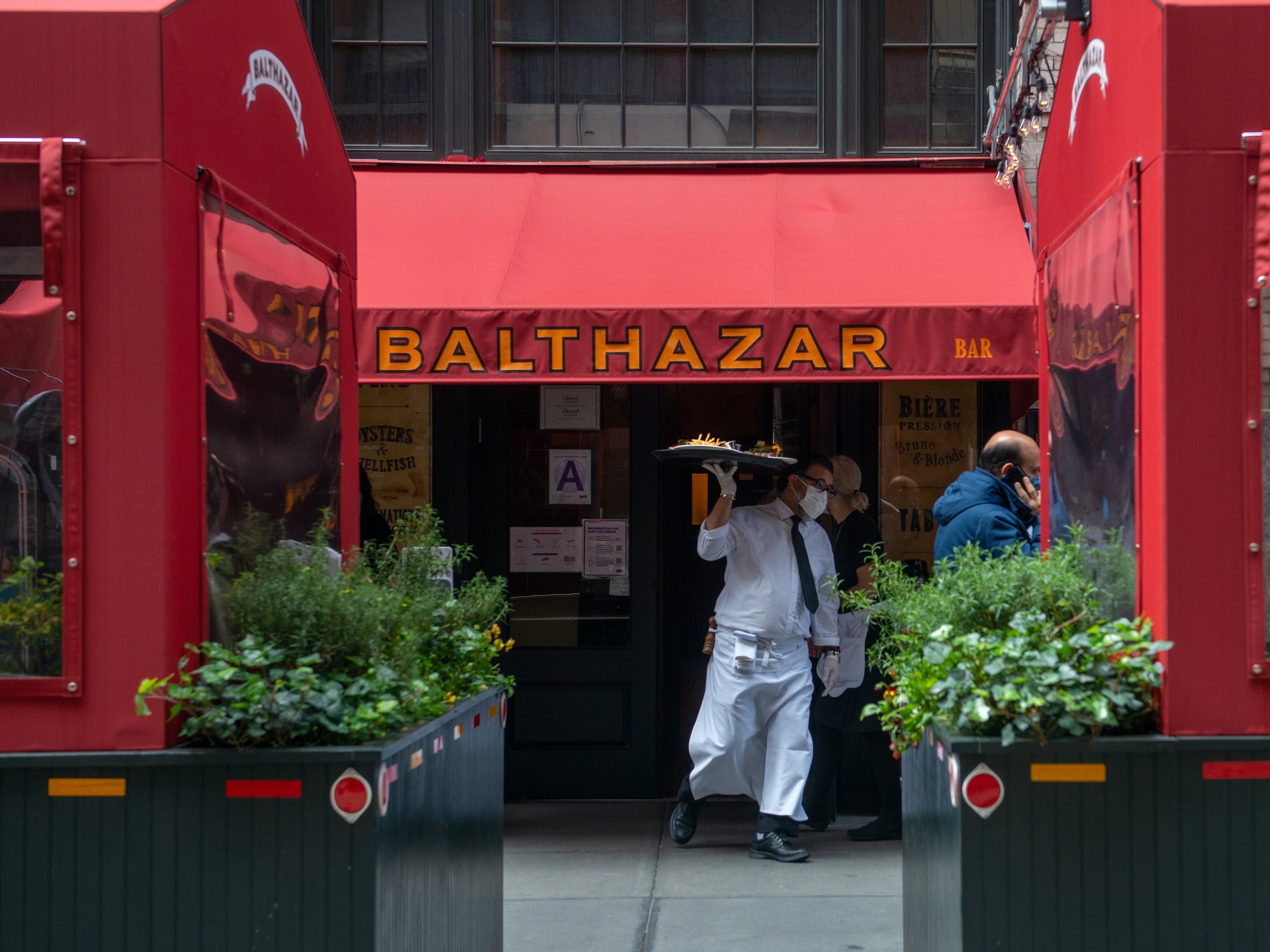 Waiter outside of Balthazar restaurant in New York City