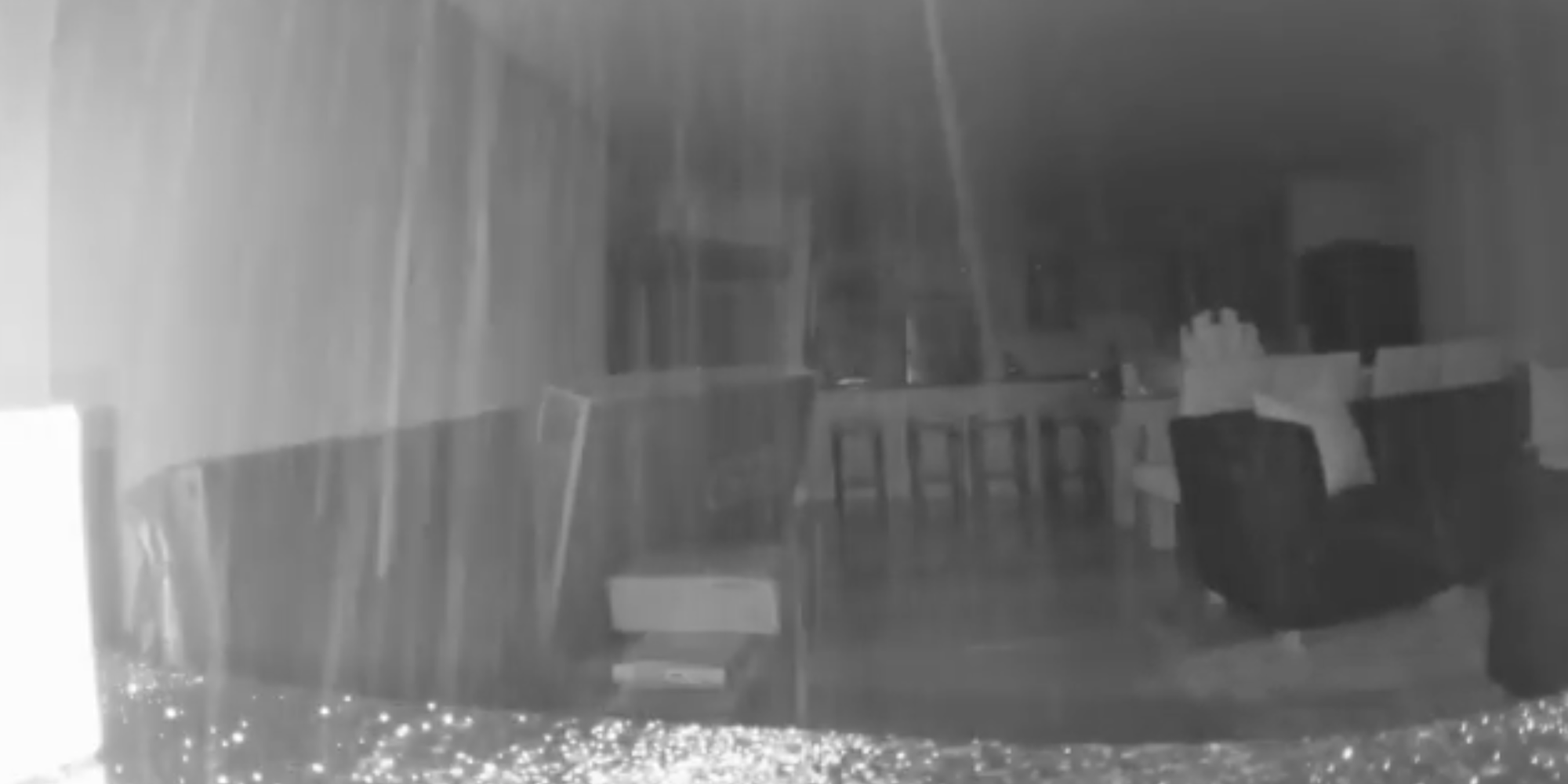 A screenshot from a video showing concrete raining down inside an apartment block