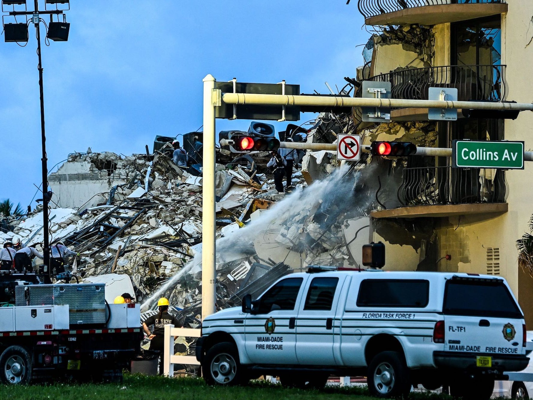 Search and Rescue personnel work as Miami-Dade firefighters spray water the ruins of the collapsed building in Surfside, Miami Beach, on June 24, 2021