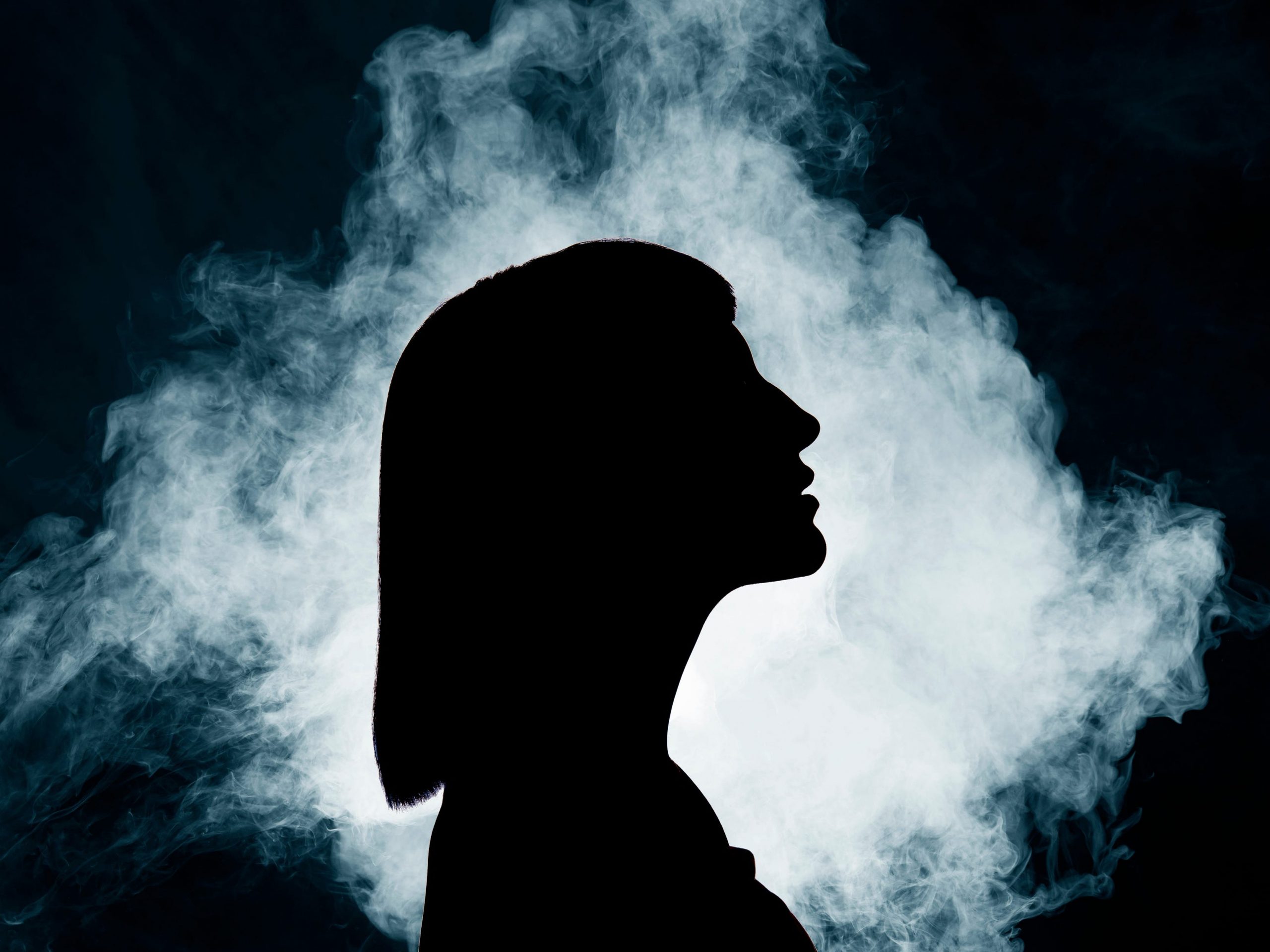 A woman with smoke behind more.