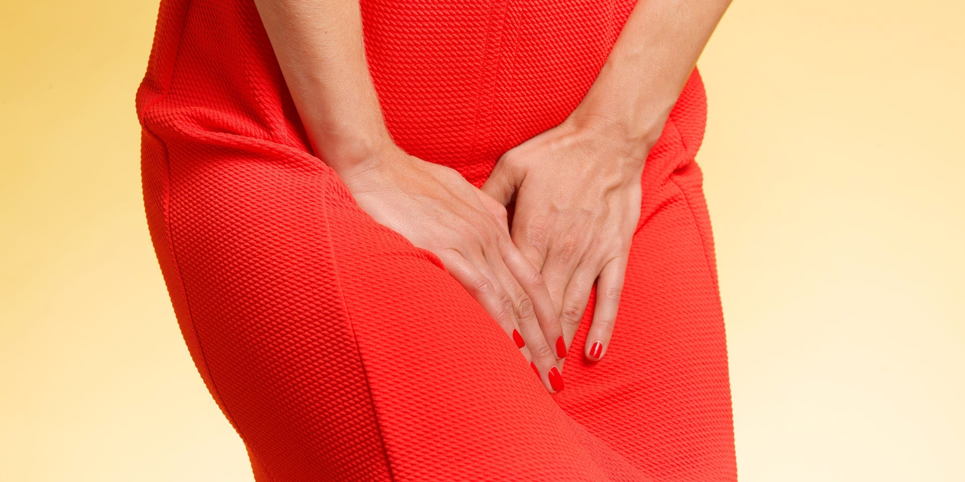woman clutching bladder or vagina
