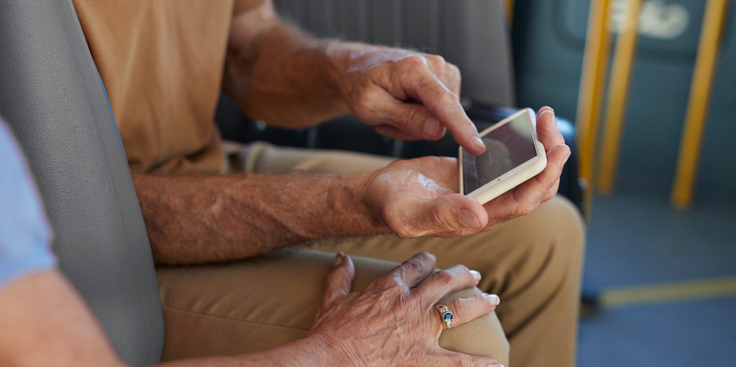 senior couple looking at smartphone