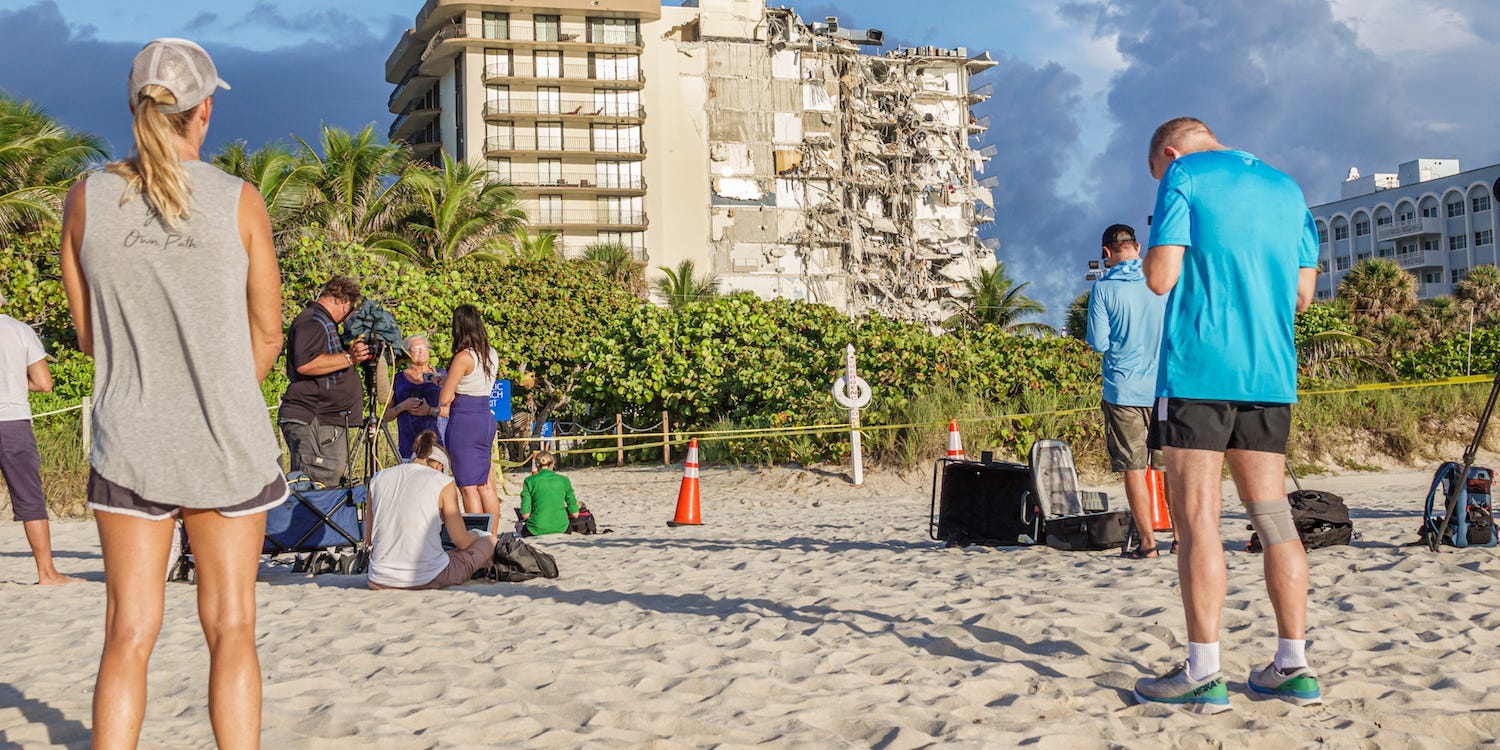 People look at Champlain Towers condominium, in Surfside, Miami Beach
