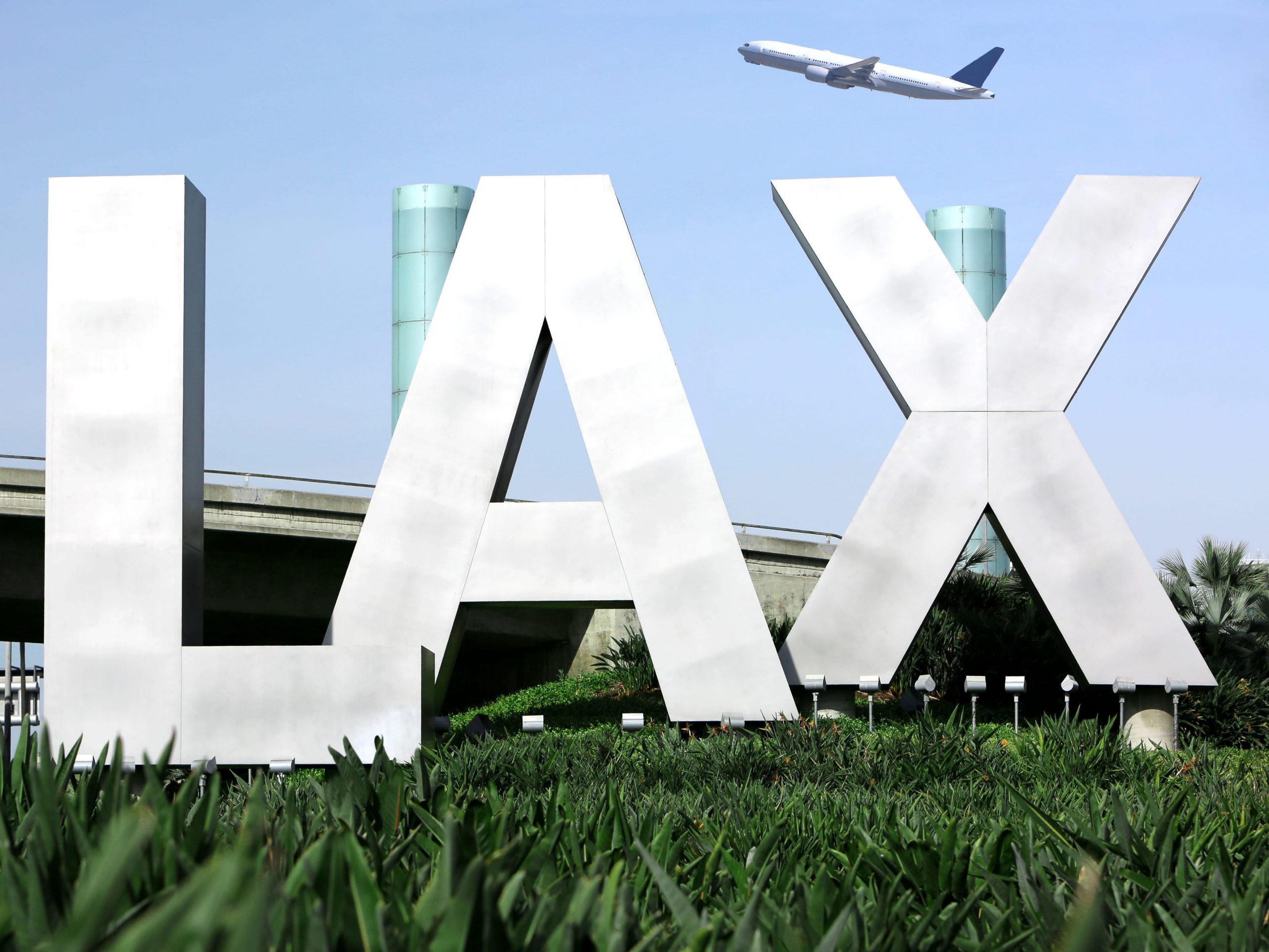 Los Angeles Airport sign with airplane flying.