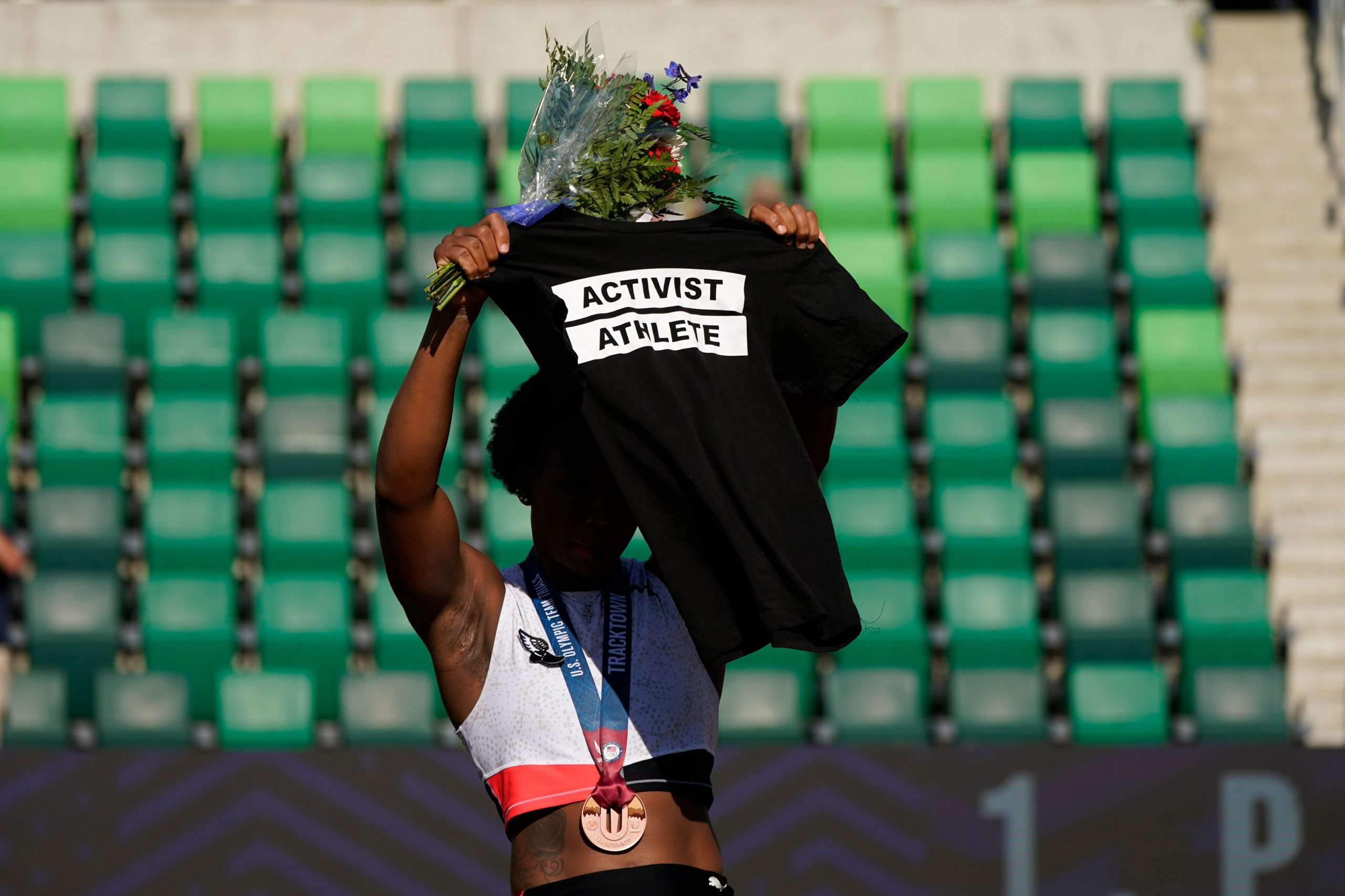 Olympic hammer thrower, Gwen Berry, places Black t-shirt that says: “Activist Athlete” over her head at U.S. Olympic Trials on Saturday.