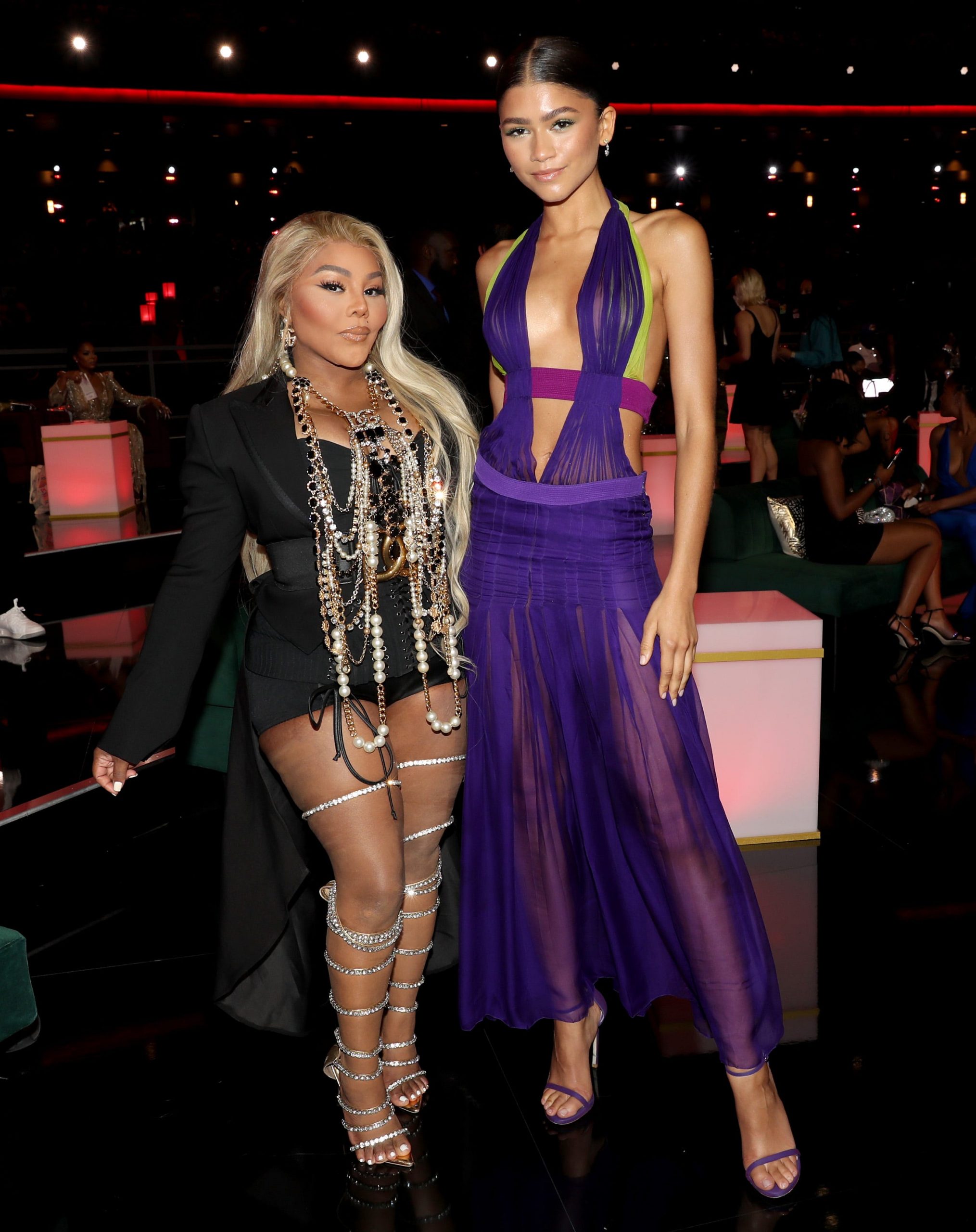 Zendaya (right) posed with Lil' Kim (left) at the BET Awards while wearing a floor-length version of a vintage Versace look previously worn by Beyoncé.