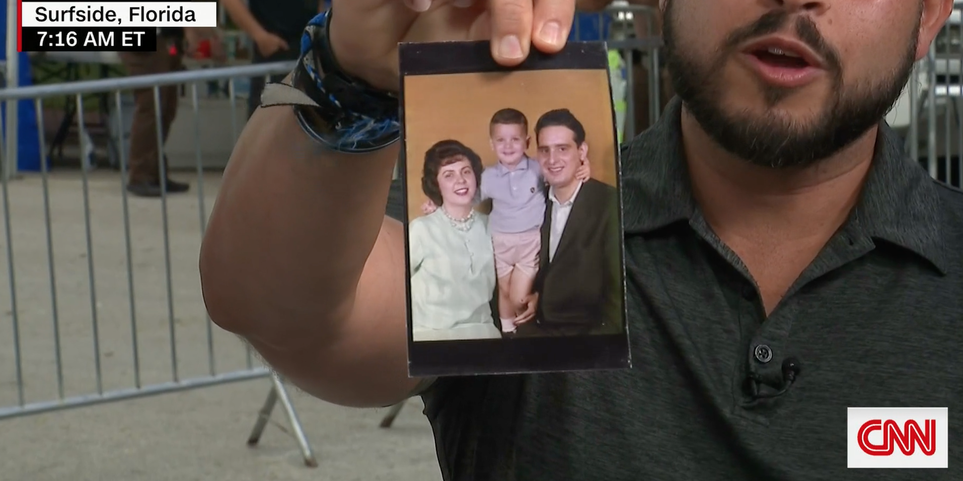 Michael Noriega holds up what he said was a family photograph owned by his 92-year-old grandmother that his family found in the debris.