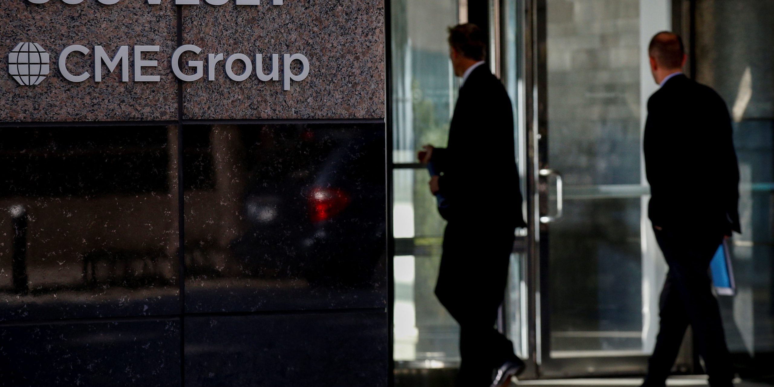 FILE PHOTO: Men enter the CME Group offices in New York, U.S., October 18, 2017. REUTERS/Brendan McDermid