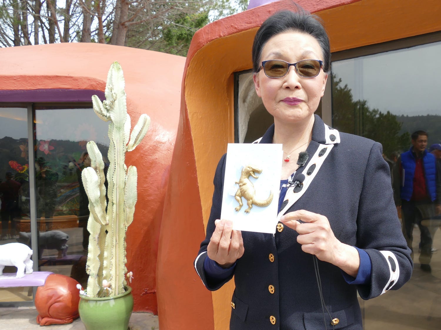 Homeowner Florence Flag stands outside of her Flintstone House