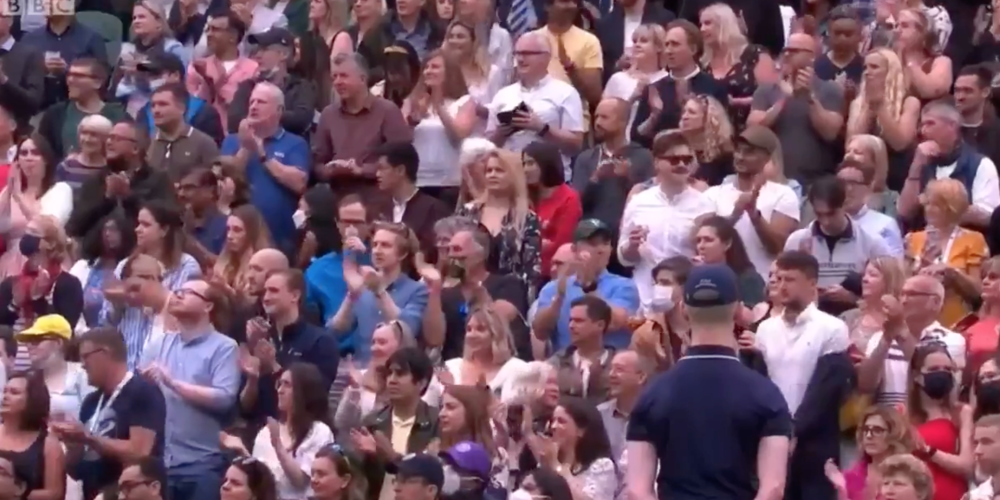 A screenshot from video footage of people standing to clap for the vaccine development team at Oxford University.